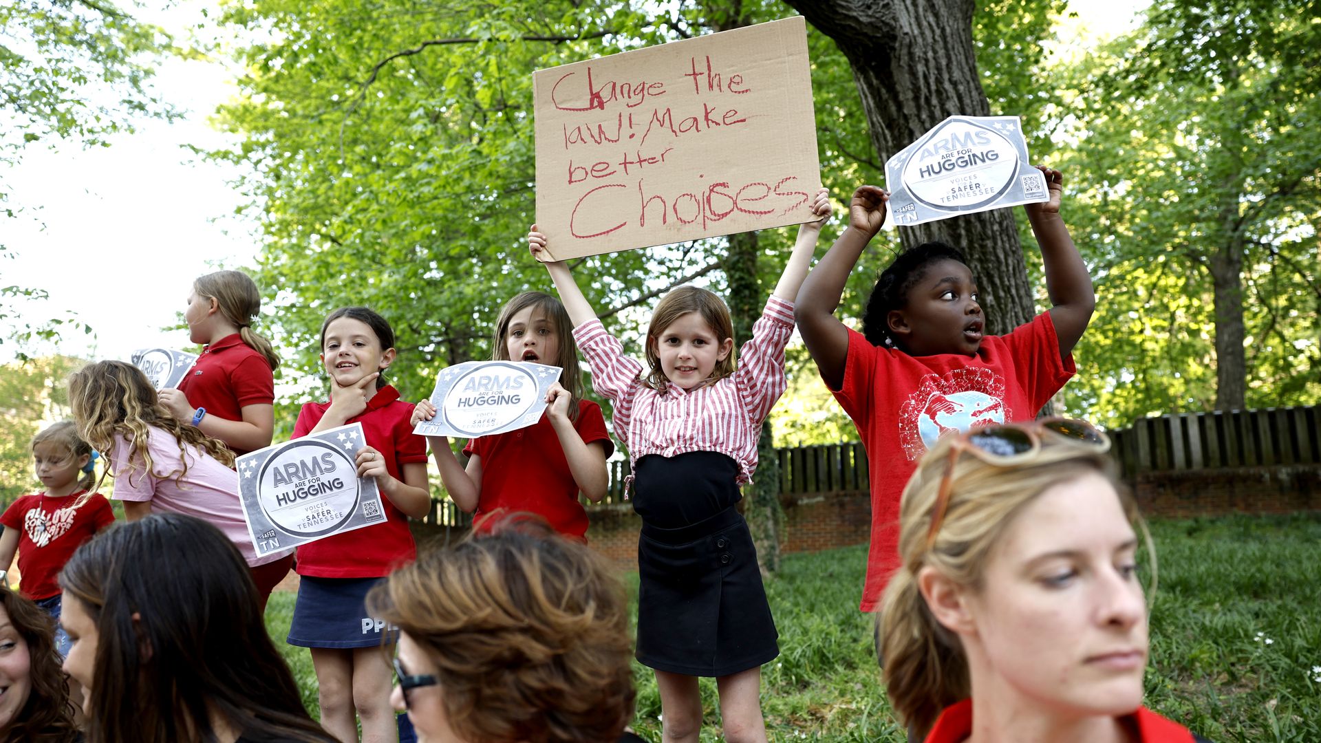 Children participate in a demonstration of linking arms in support of gun control laws
