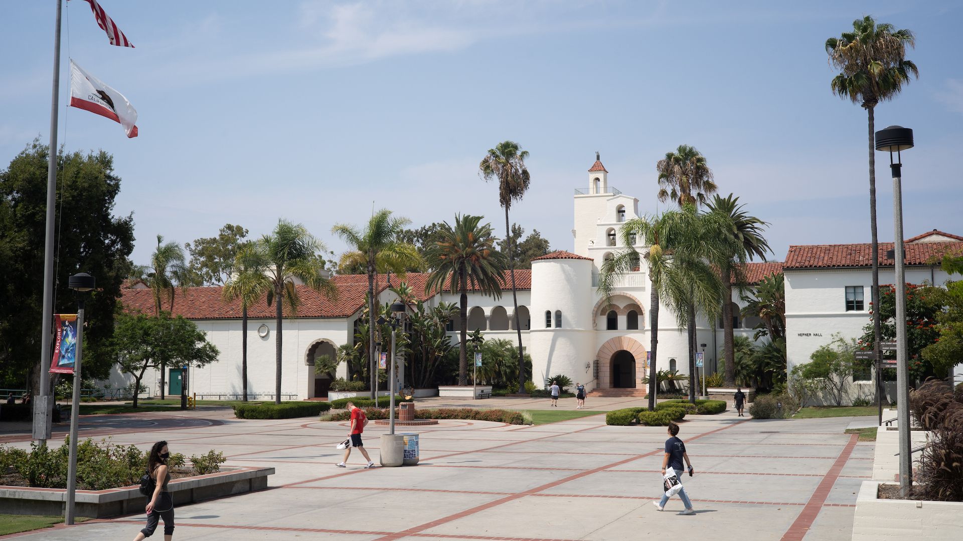 A campus building with students walking at San Diego State University.