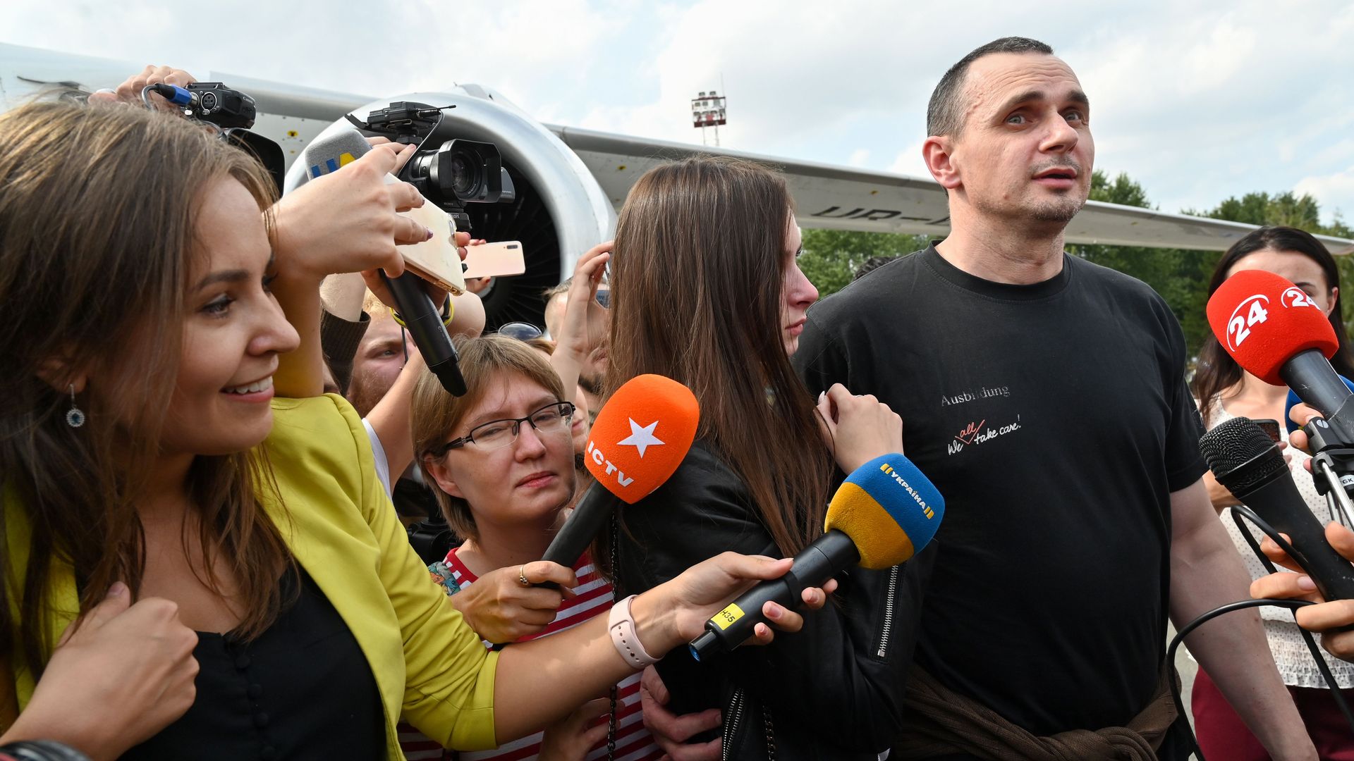 Ukrainian filmmaker and activist Oleg Sentsov chats with reporters after being released from Russia