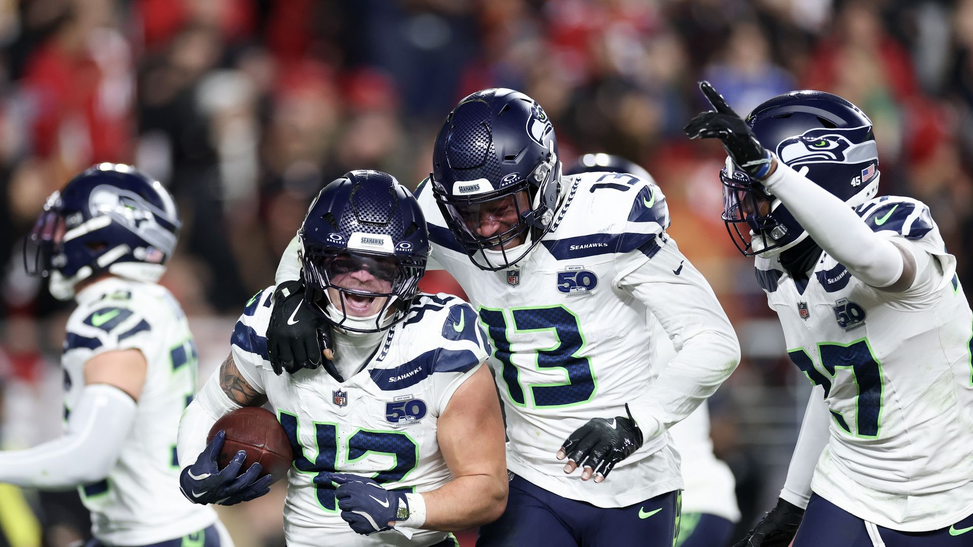  Drake Thomas #42 of the Seattle Seahawks celebrates with Ernest Jones IV #13 and Riq Woolen #27 after intercepting a pass from Brock Purdy (not shown) of the San Francisco 49ers during the fourth quarter of a game at Levi's Stadium on January 03, 2026 in Santa Clara.