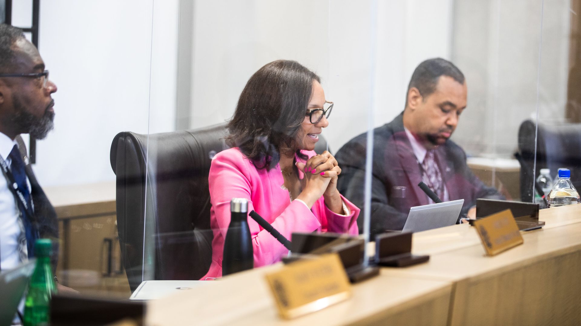 Three council members sit at a table in a row during a meeting, with President Mary Sheffield in the center speaking.