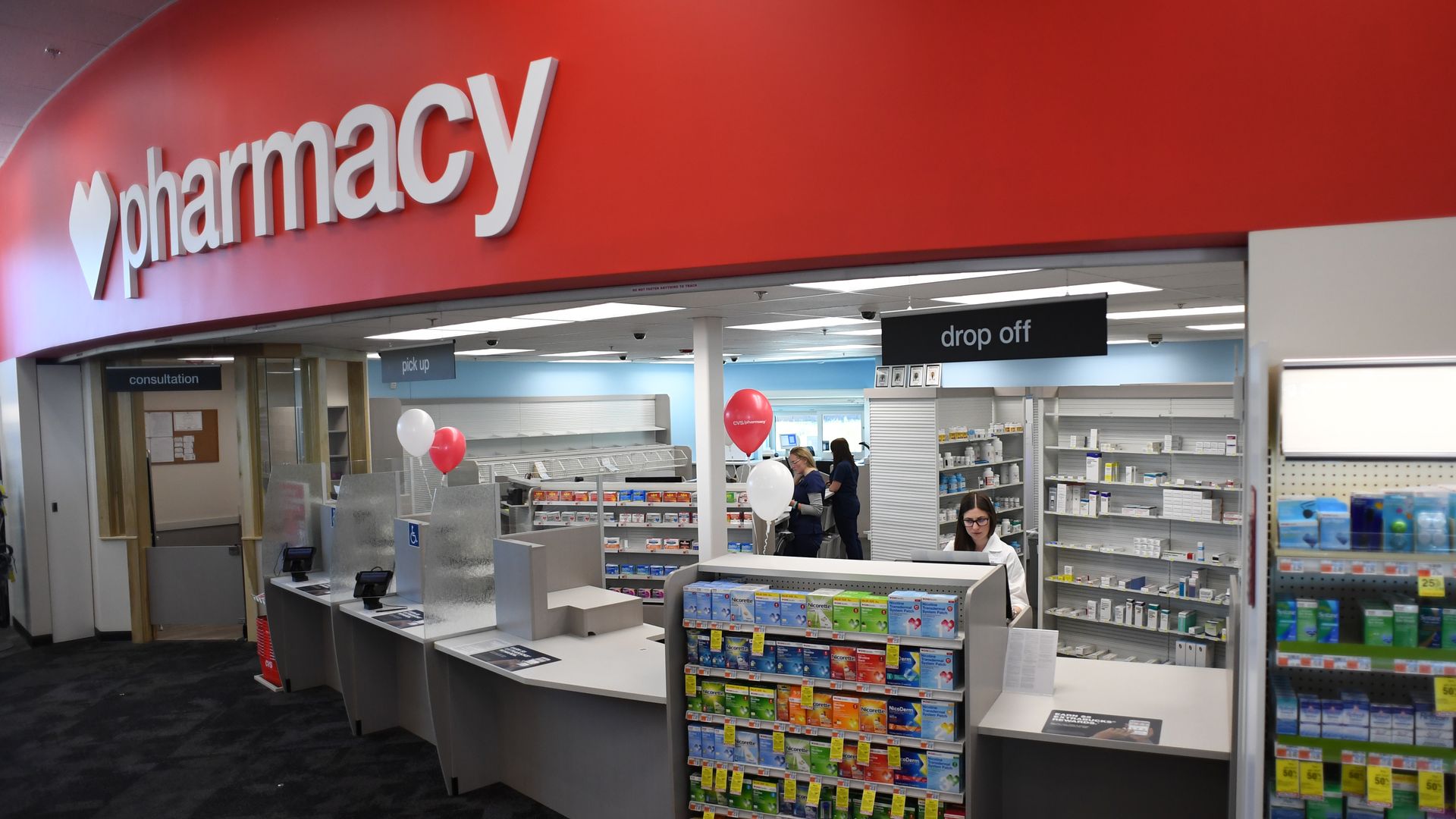 A CVS pharmacist works behind the counter.