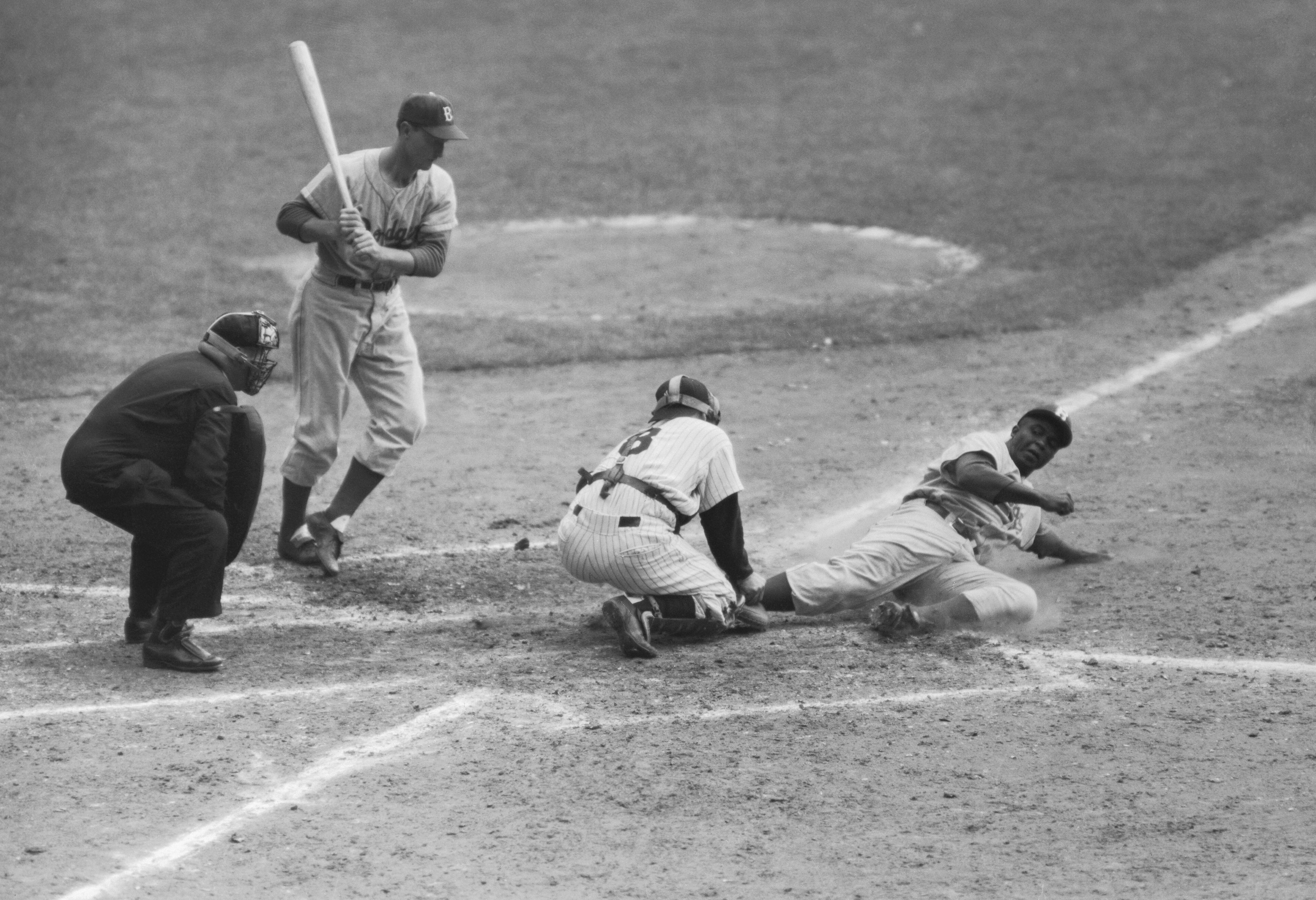Jackie Robinson steals home during the 1955 World Series.