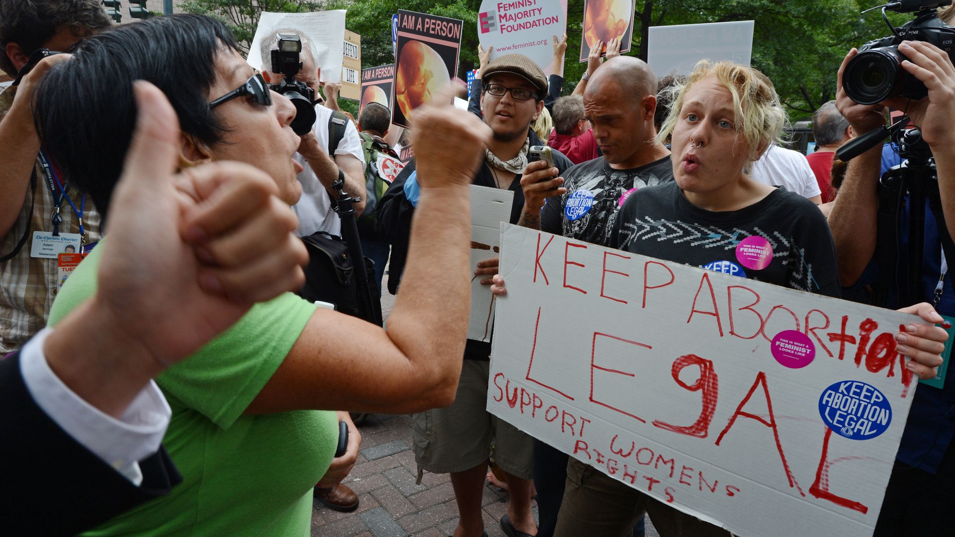 An abortion rights activist argues with a local resident while protesting in Charlotte, North Carolina, in 2010. Photo credit should read ROBYN BECK/AFP/GettyImages)