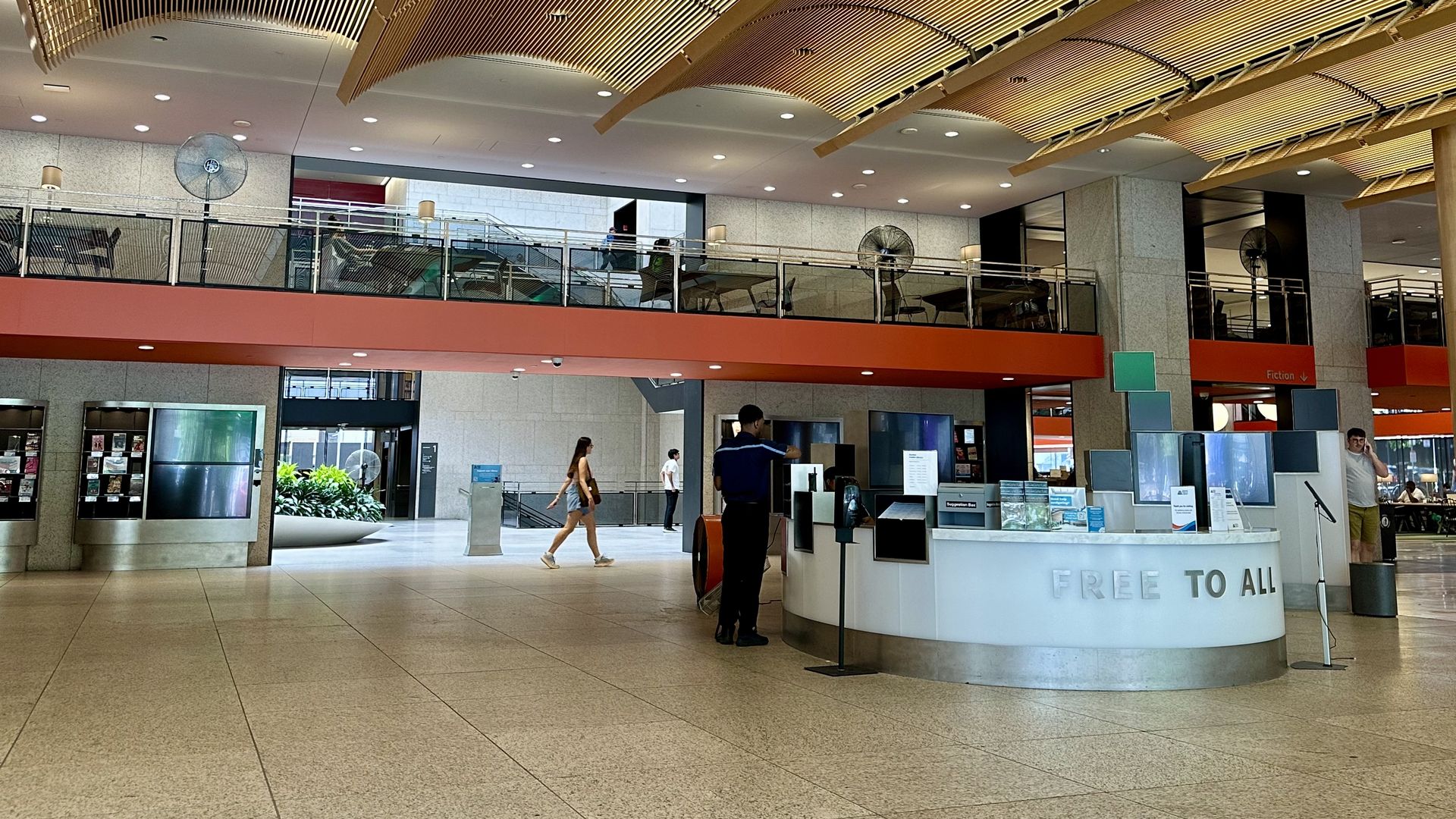 The new entrance to the Boston Public Library's Copley branch, showing large fans on the mezzanine and main floor due to the AC being off.