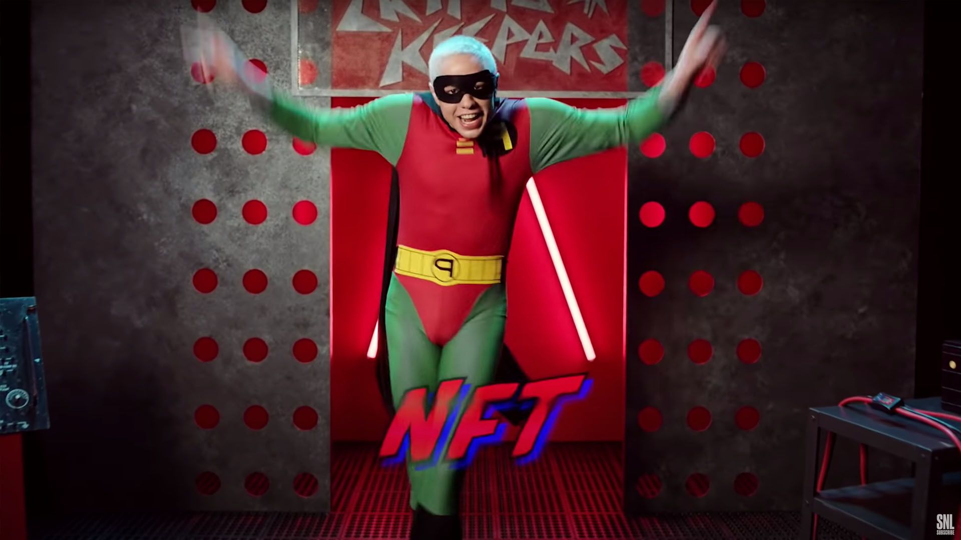 Saturday Night Live comedian Pete Davidson dressed in a Robin costume parodying rapper Eminem with the word NFT in graphics in the foreground