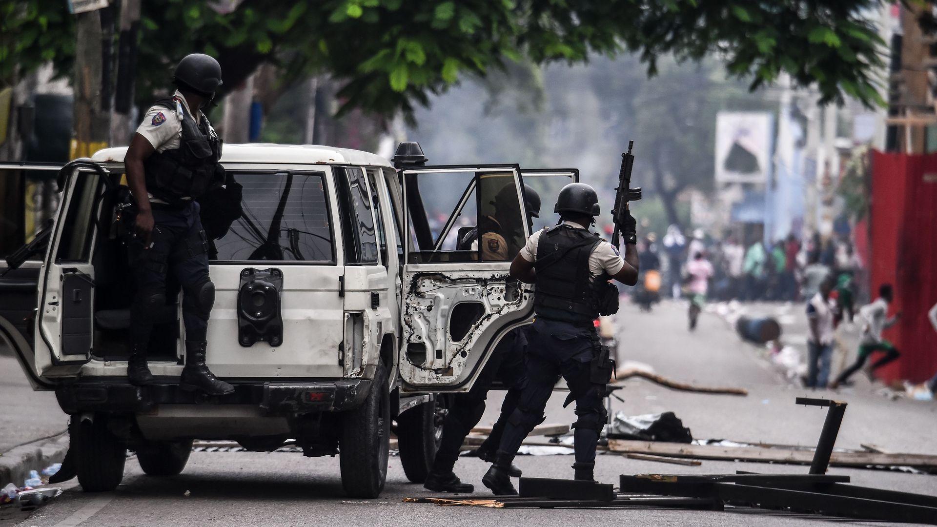 Police clear the streets as demonstrators protest.