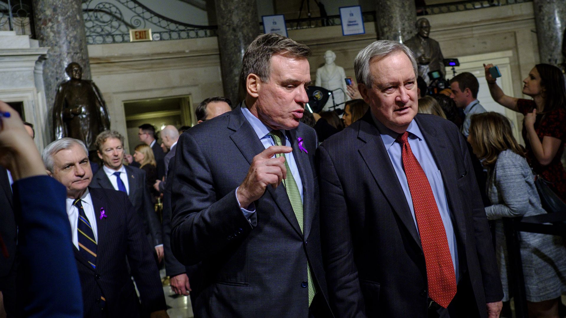 Senator Mark Warner walks with a colleague