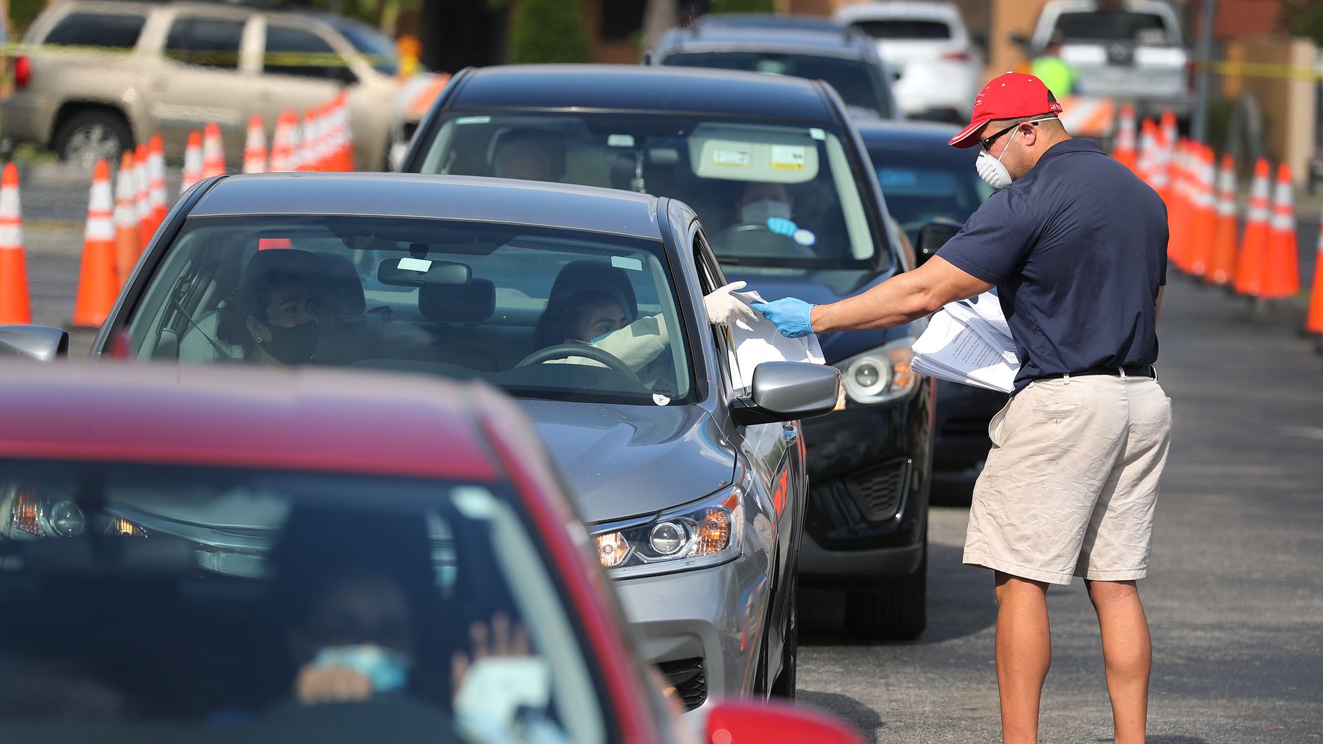 Cars lined up to recieve unemployment paperwork