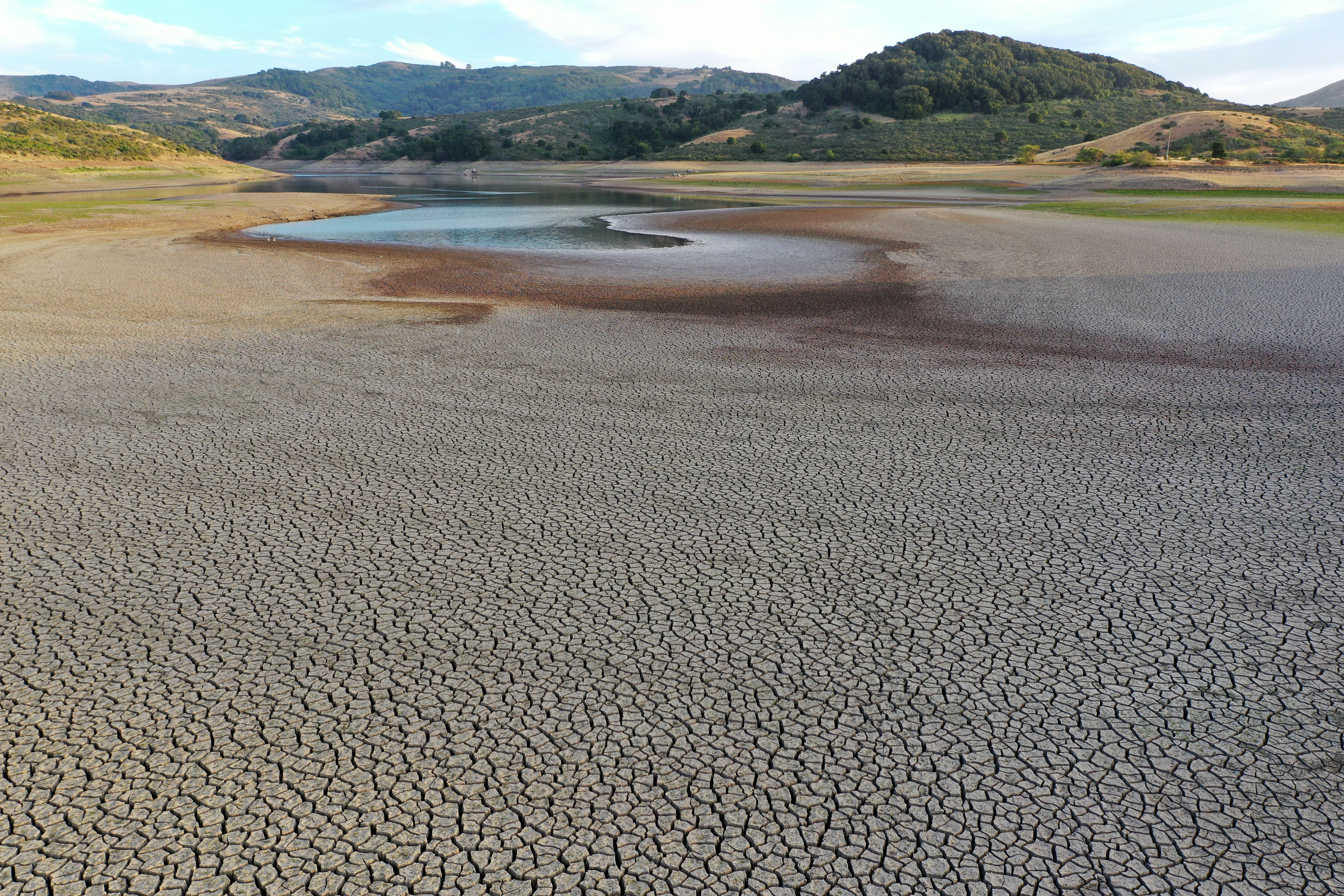Dry cracked earth is visible at Nicasio Reservoir on June 16, 2021 in Marin County, California, which is under mandatory water-use restrictions 