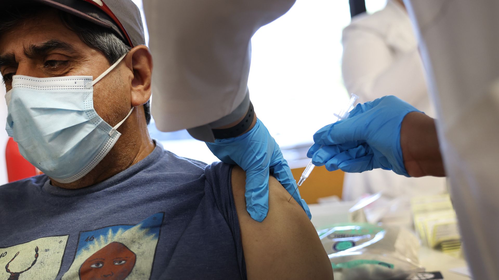 Ramiro Guzman receives a COVID-19 booster during an event hosted by the Chicago Department of Public Health at the Southwest Senior Center earlier this month.