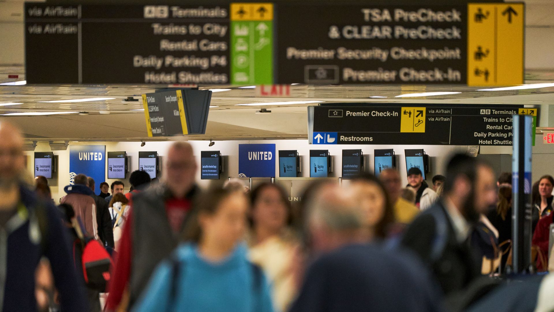 Travelers at a United Airlines Holdings Inc. check-in area in Terminal C of Newark Liberty International Airport (EWR) in Newark, New Jersey, US, on Tuesday, May 6, 2025. United Airlines Holdings Inc. will cut 35 daily round trips at Newark Liberty International Airport after Federal Aviation Admini