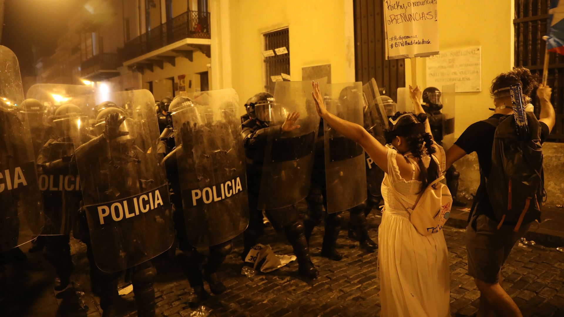 Demonstrators and police face off during a protest against Ricardo Rossello.