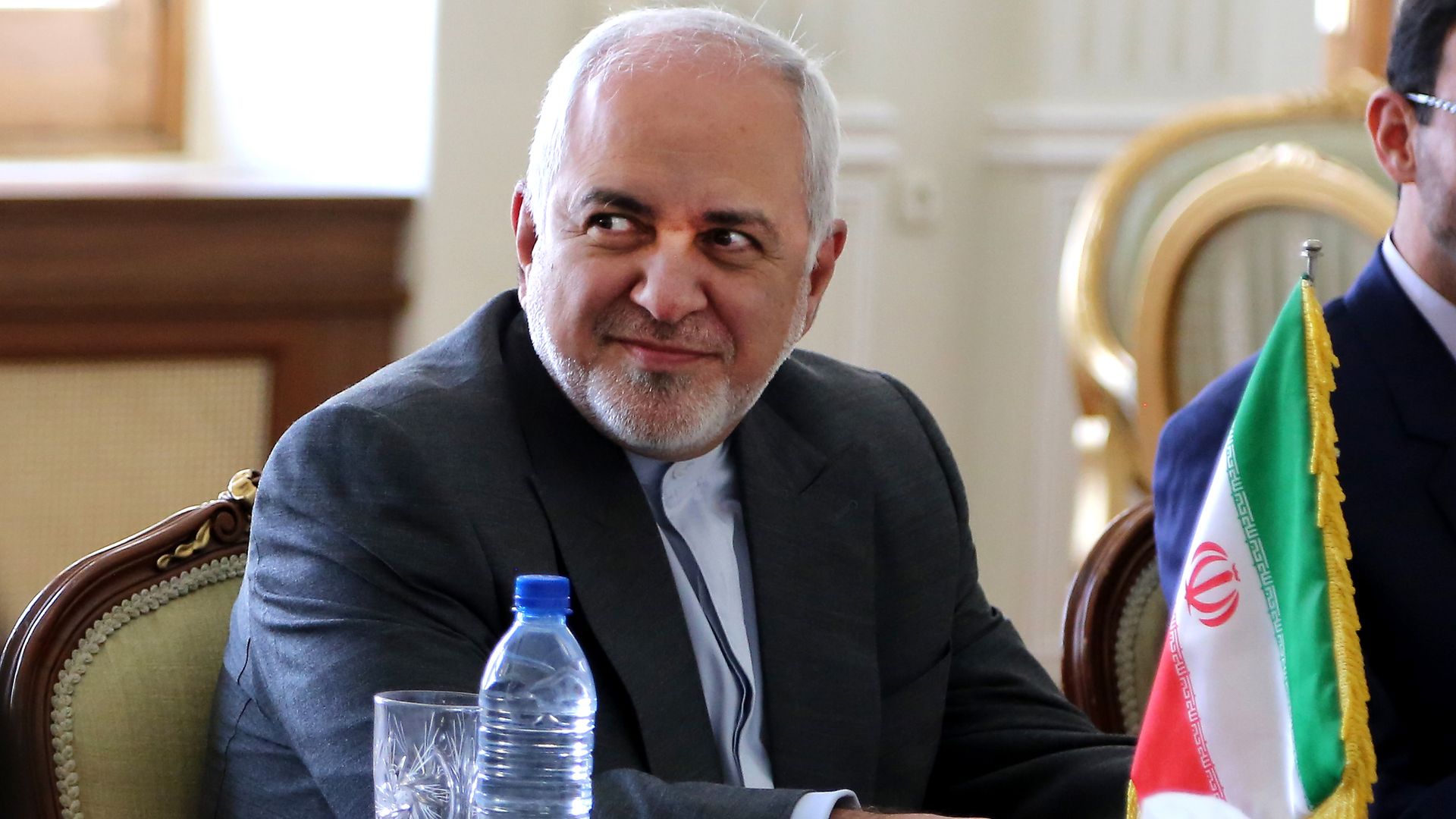 Mohammad Zarif seated at a conference table