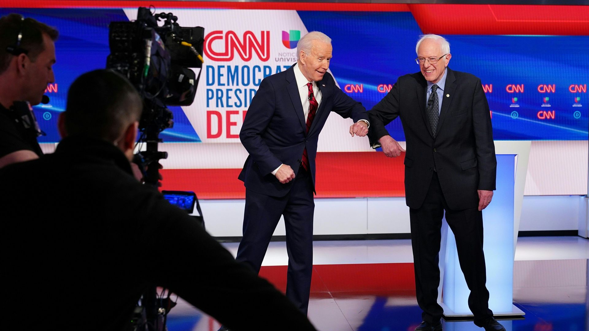 Joe Biden and Bernie Sanders bumping elbows