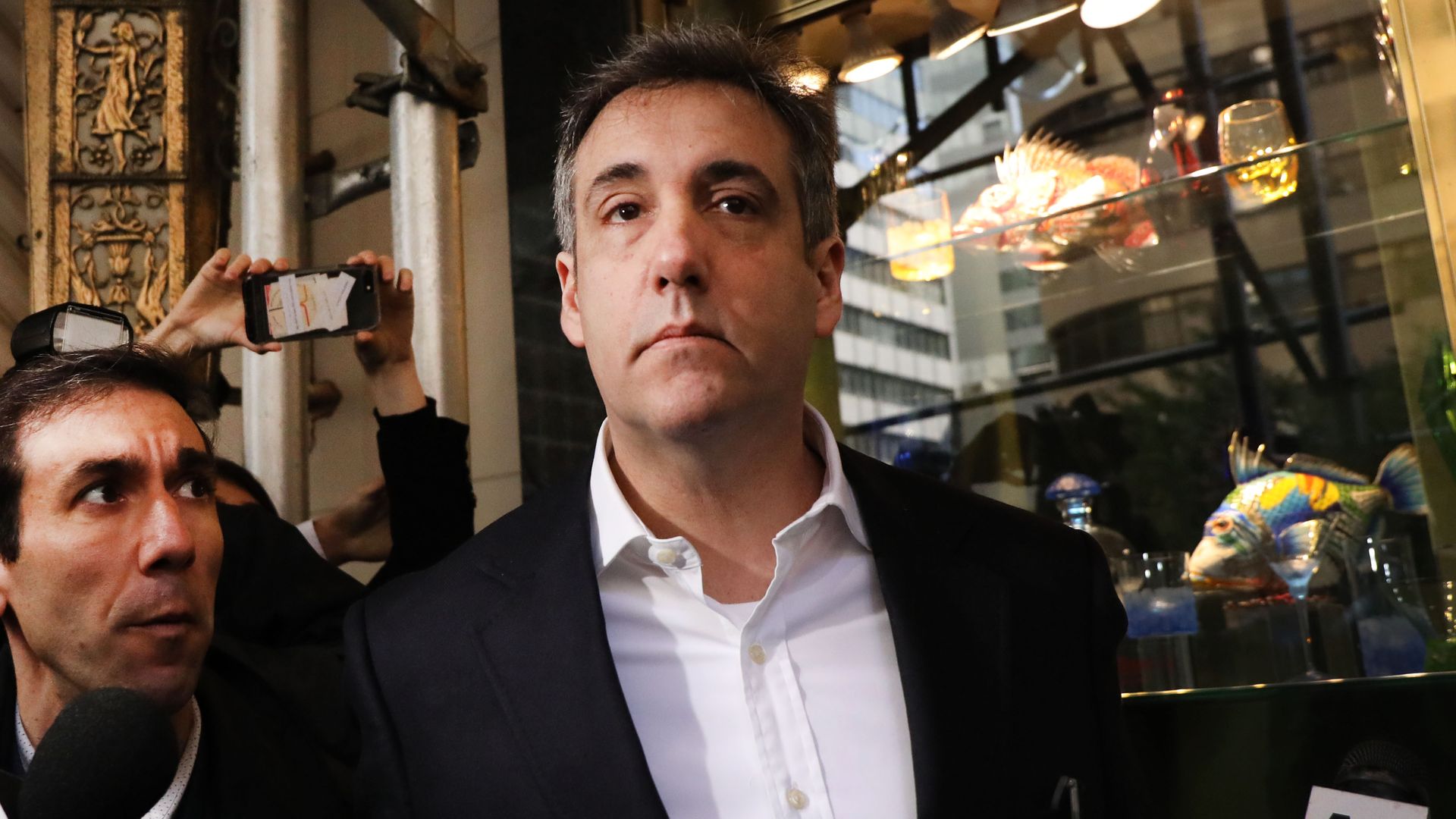 Cohen surrounded by press.