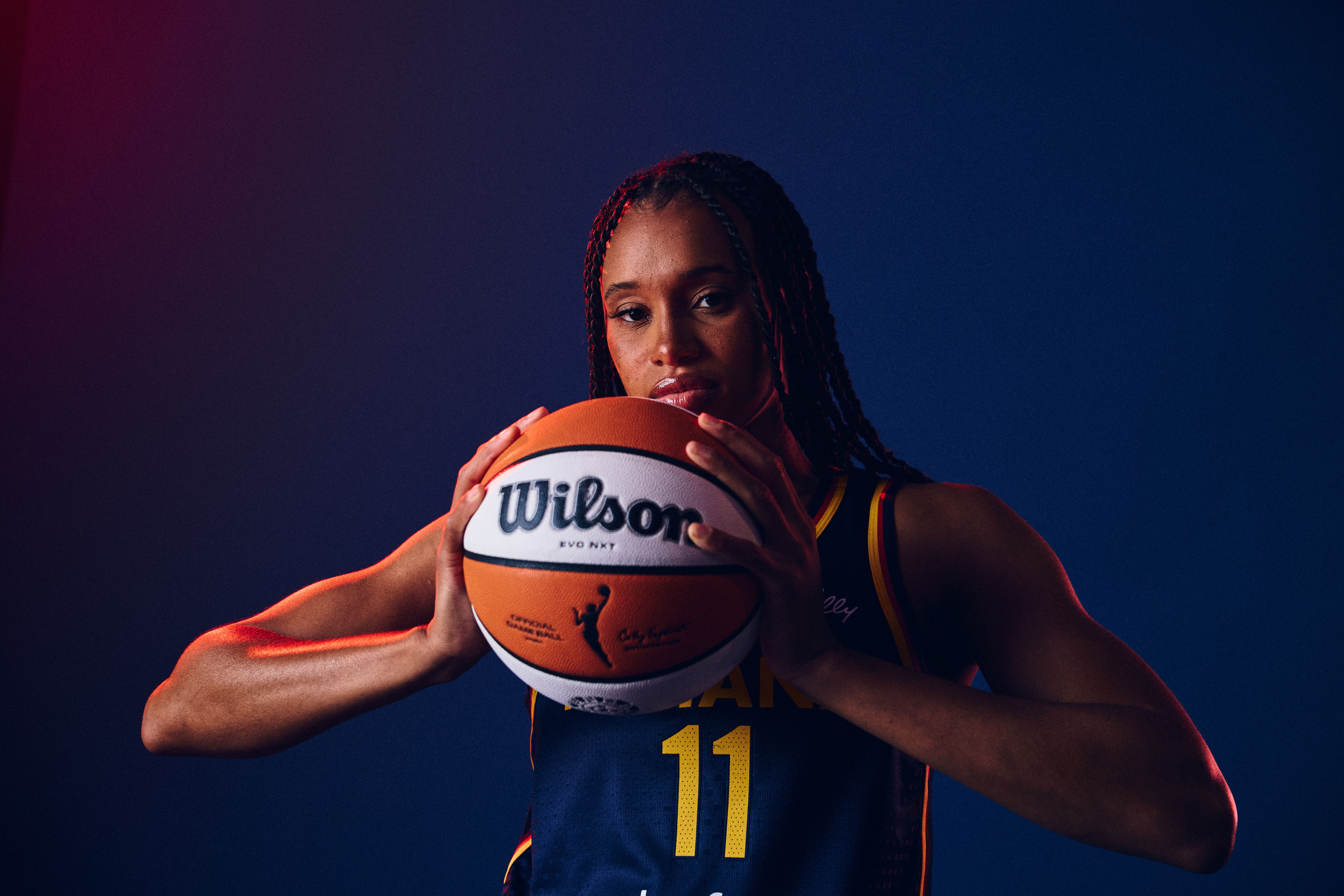 Brianna Turner poses with a basketball for media day