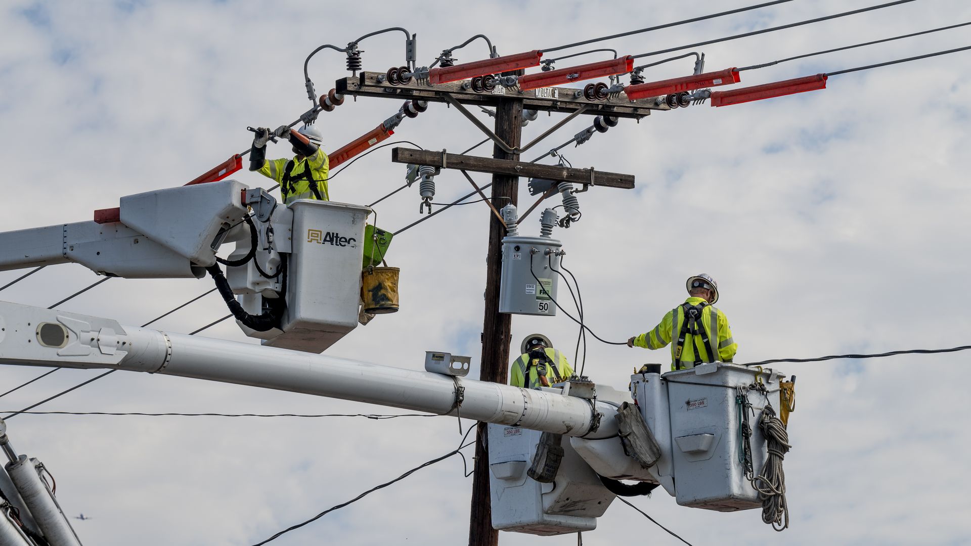 Utility workers replacing a transformer that was damaged by a storm in Santa Ana, California, in September 2021.