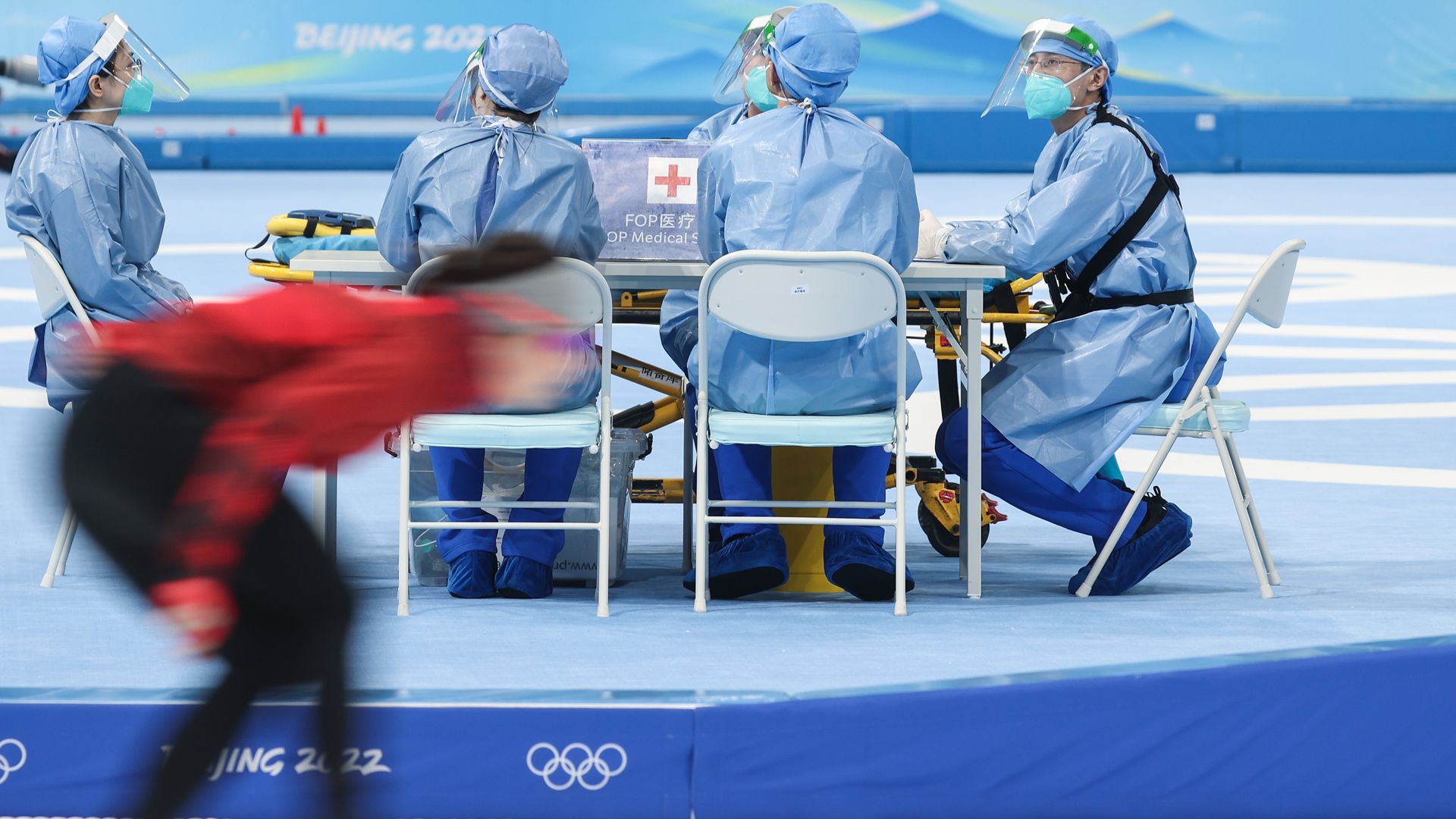 Healthcare workers are seen during women's 3000m speed skating race during the Beijing 2022 Winter Olympic Games at the National Speed Skating Oval