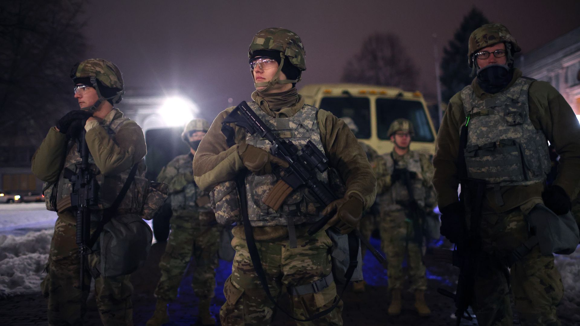 National Guard troops stand watch as demonstrators protest outside of the Kenosha County Courthouse.
