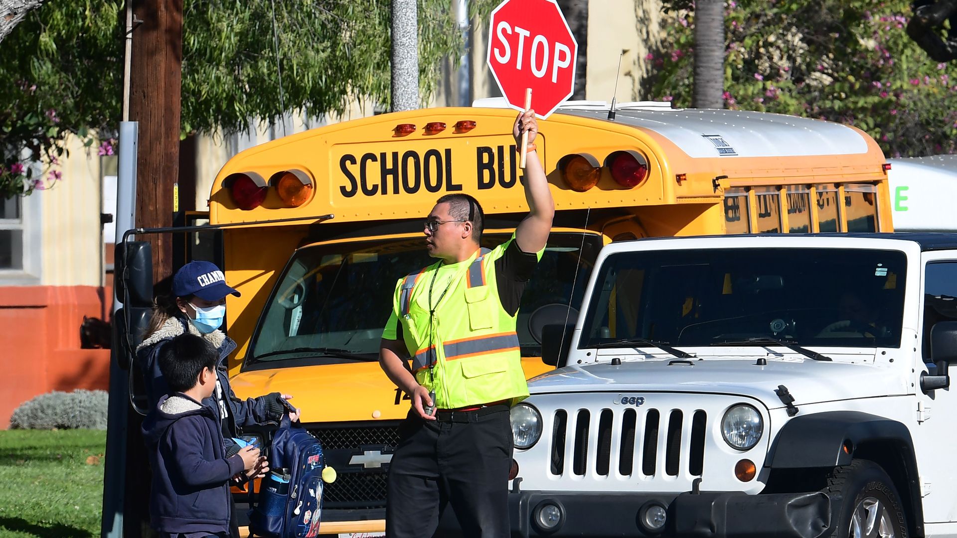 Alhambra Unified School District as a crossing guard stops traffic