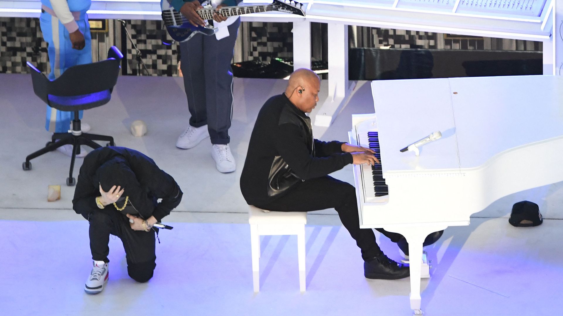 rapper Eminem takes a knee as he performs during the halftime show of Super Bowl LVI between the Los Angeles Rams and the Cincinnati Bengals at SoFi Stadium in Inglewood, California, on February 13