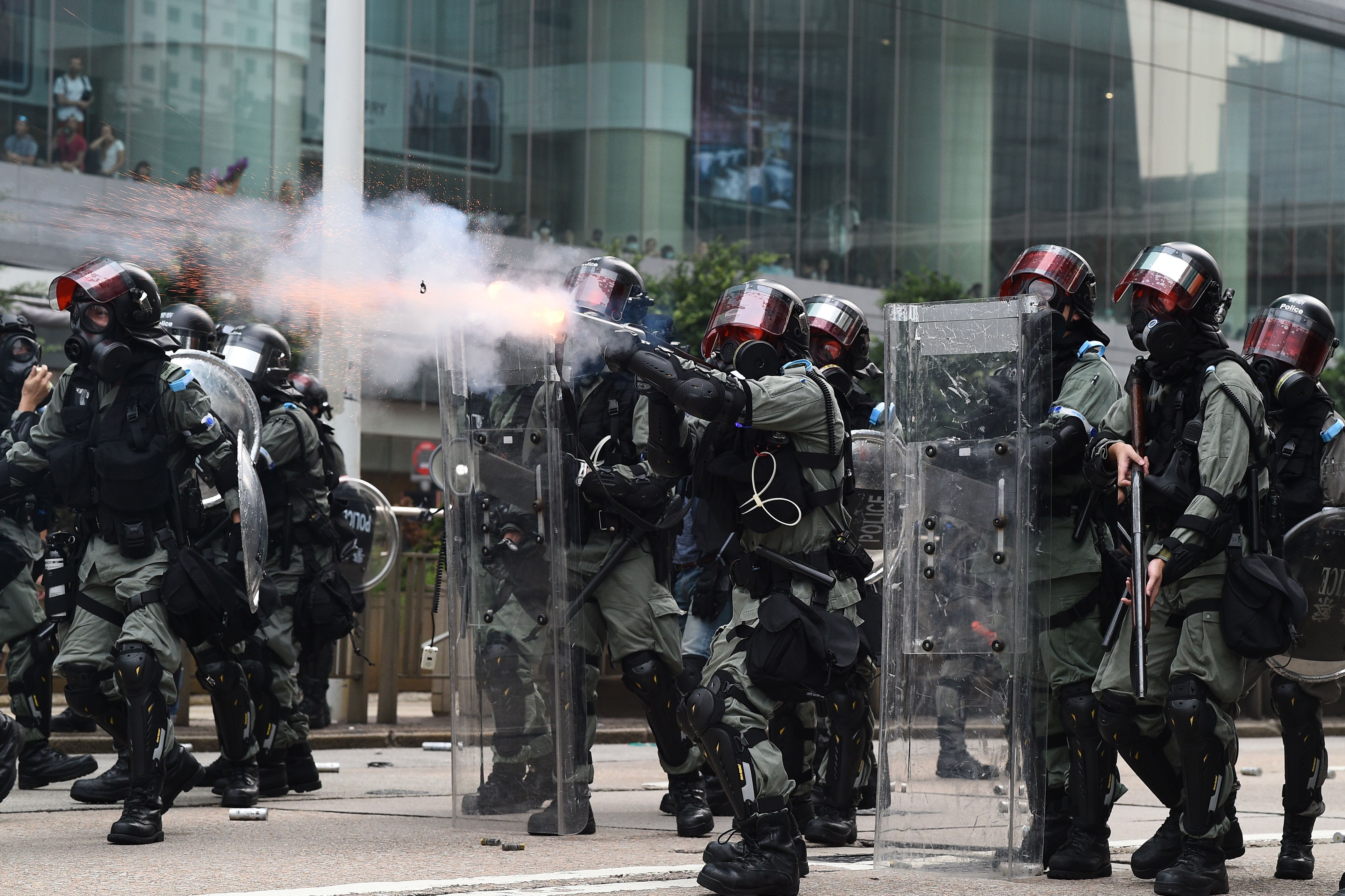 Hong Kong police fire tear gas toward protesters taking part in an unsanctioned march through the streets of Hong Kong on September 29