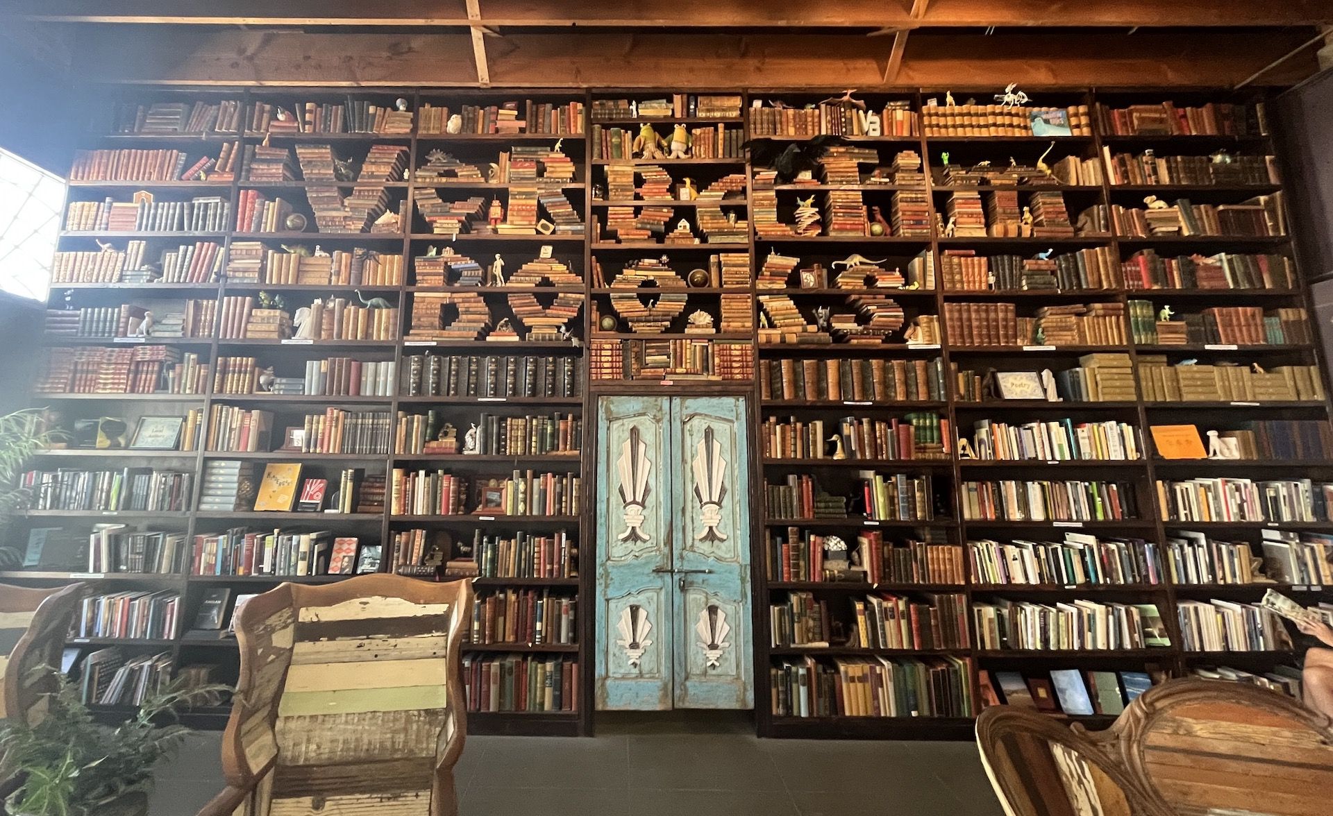 A bookshelf with "Verbatim Books" spelled out in books.