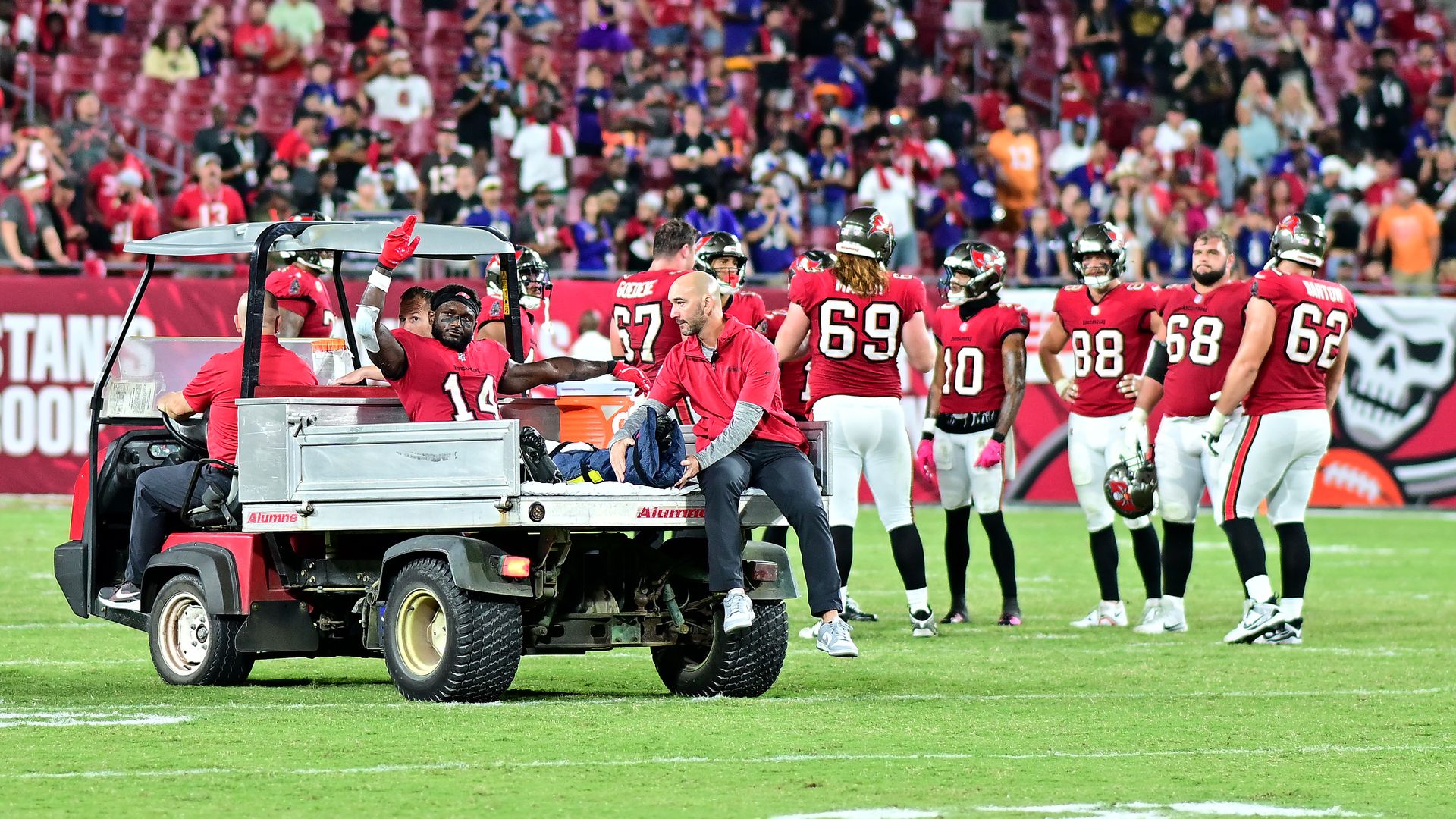 Chris Godwin #14 of the Tampa Bay Buccaneers reacts as he is carted off the field after being injured during the fourth quarter against the Baltimore Ravens.