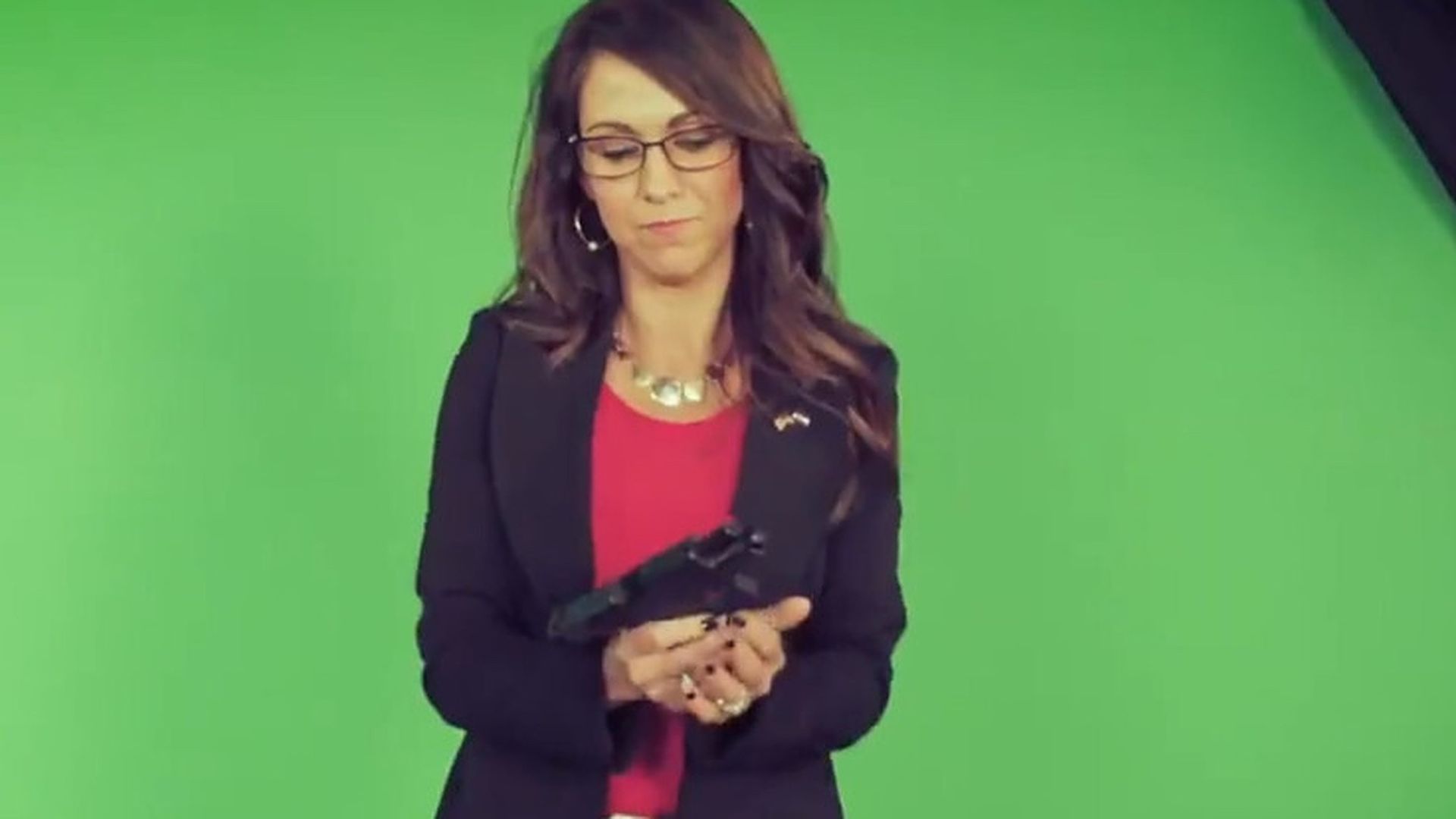 Rep. Lauren Boebert is seen holding a handgun in a screen grab from her new commercial.