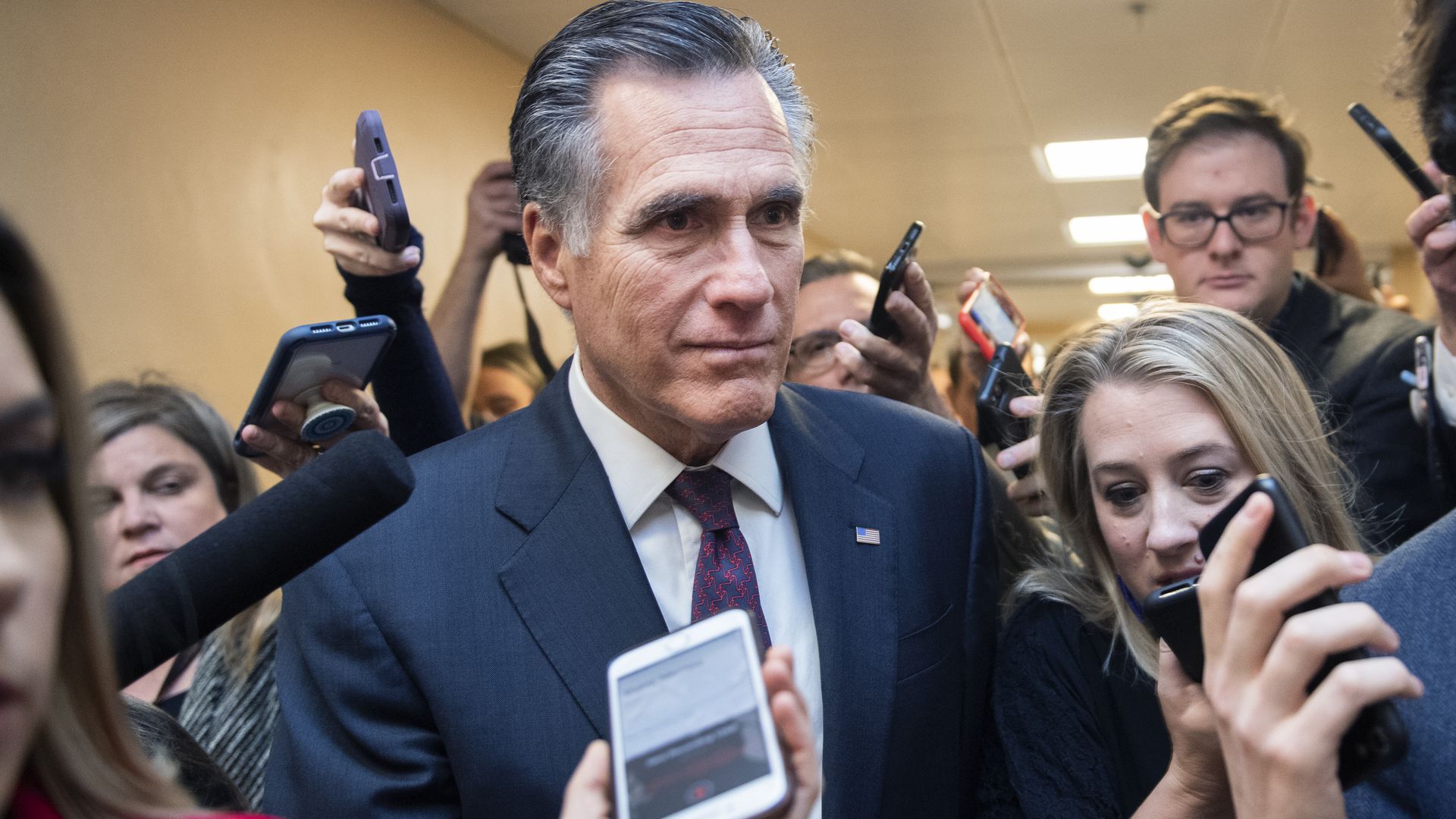 Sen. Mitt Romney, R-Utah, talks with reporters in the senate subway before the continuation of the impeachment trial