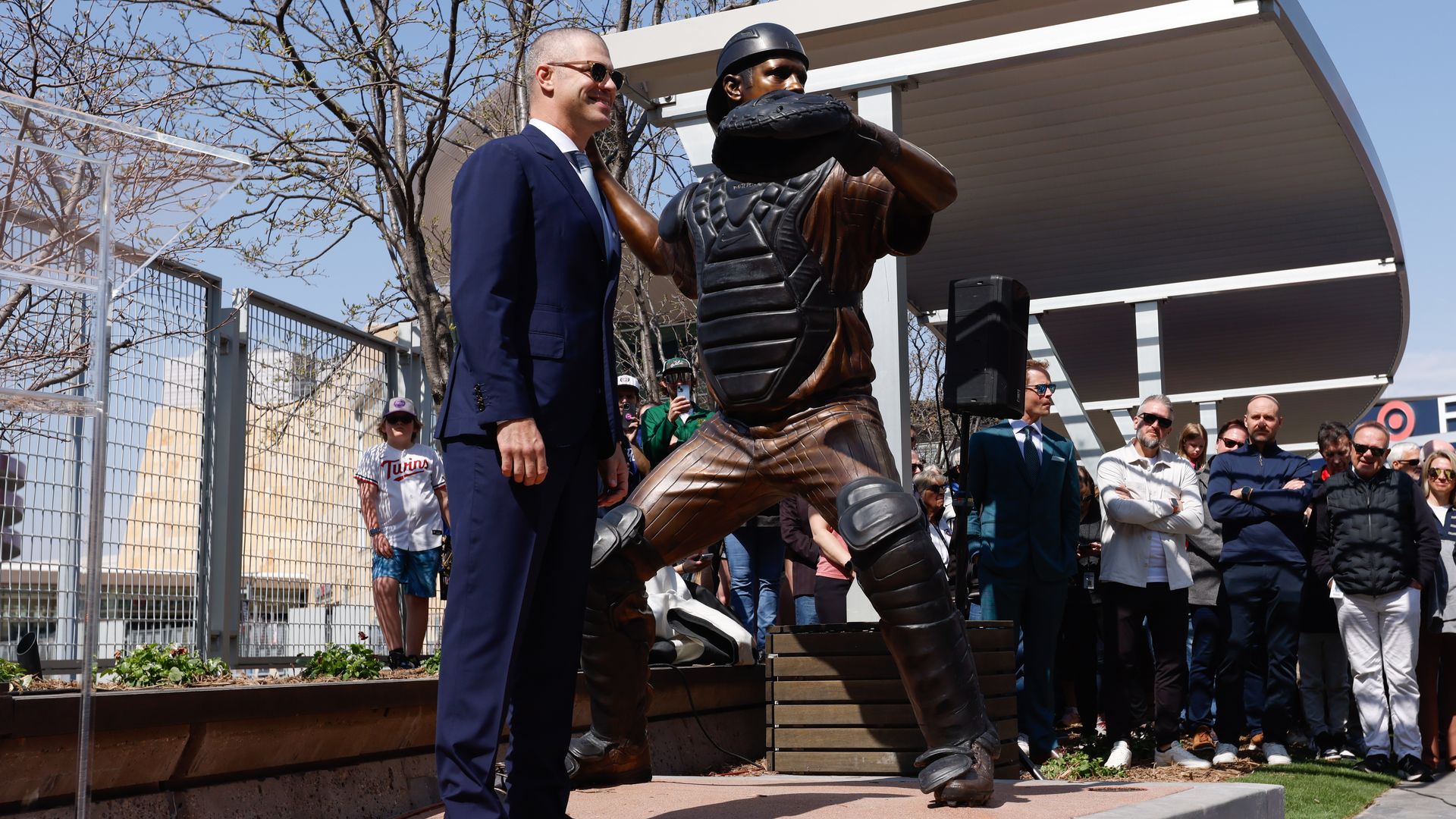 A photo showing Joe Mauer standing next to a statue of Joe Mauer