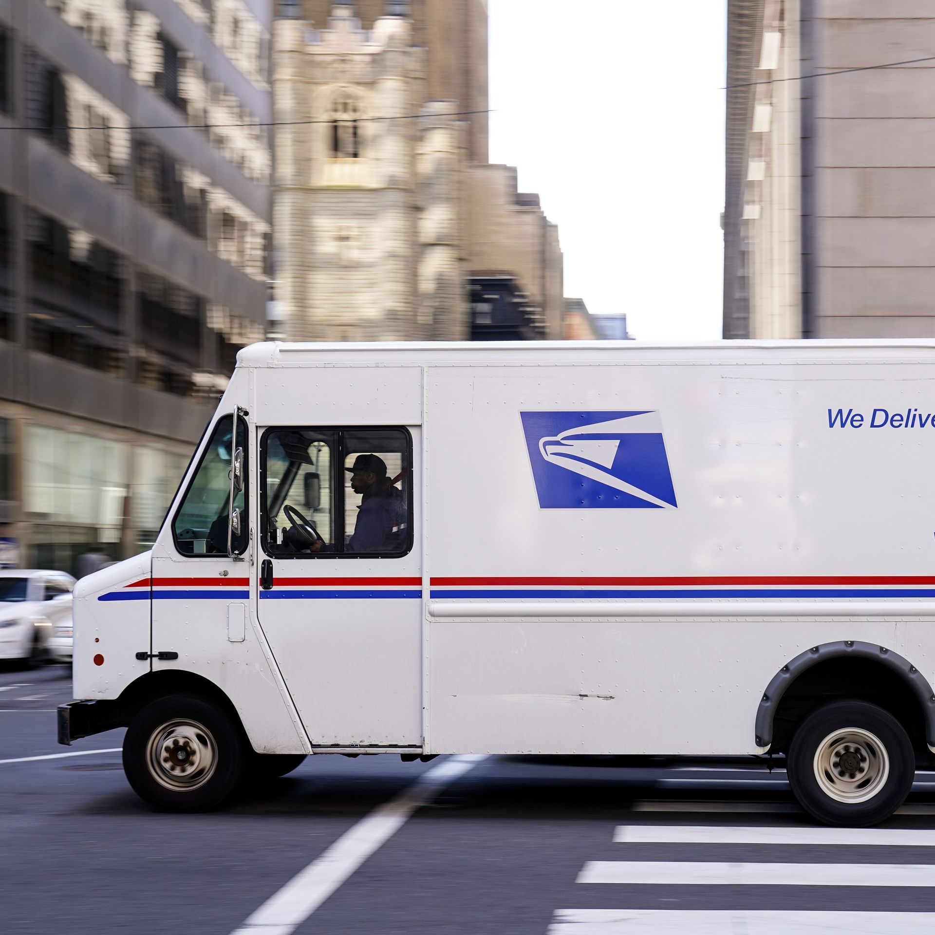 A United States Postal Service truck drives in downtown Philadelphia.