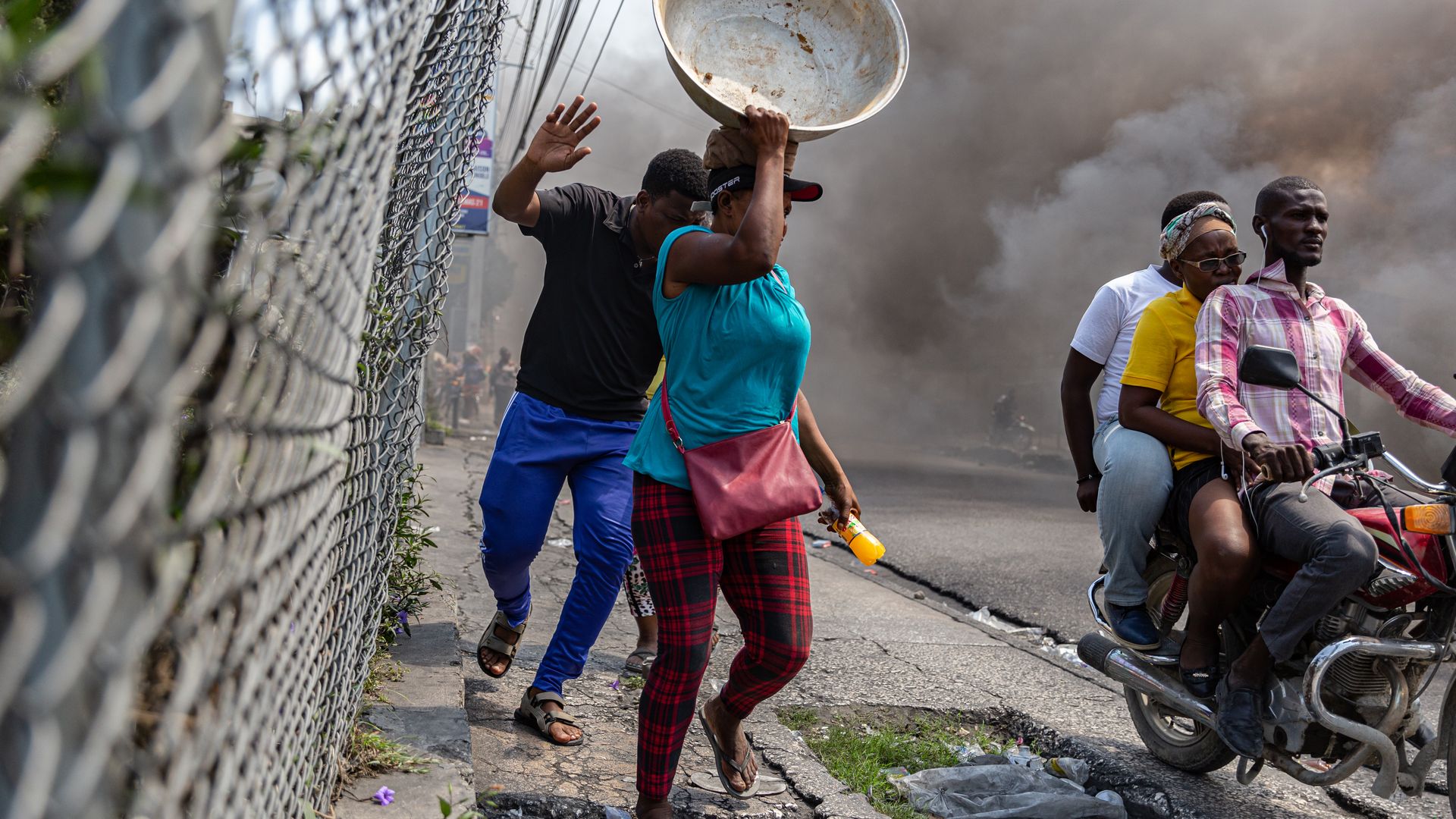People fleeing a protest in Port-au-Prince on March 12.