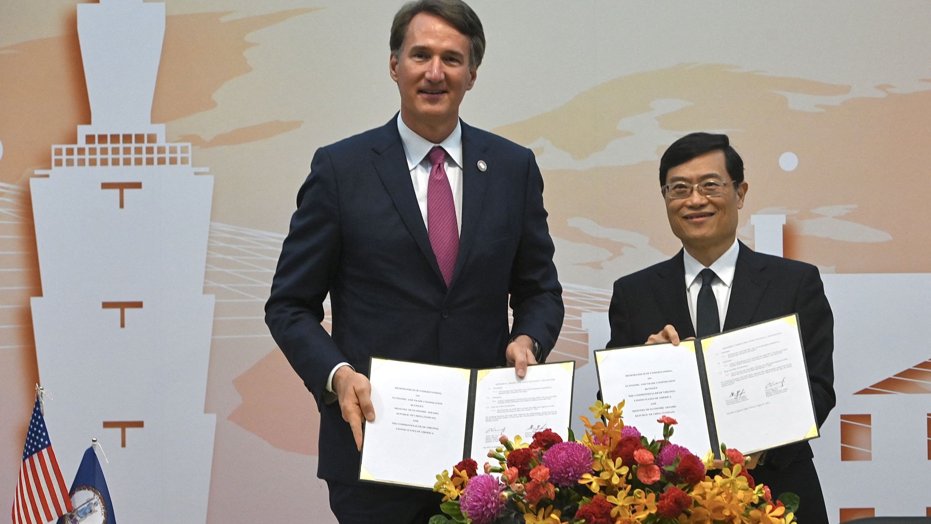 Virginia Governor Glenn Youngkin (L) poses for a photo with Taiwan's Deputy Economic Minister Chen Chern-chi during a signing ceremony at the Ministry of Foreign Affairs (MOFA) in Taipei on April 25, 2023