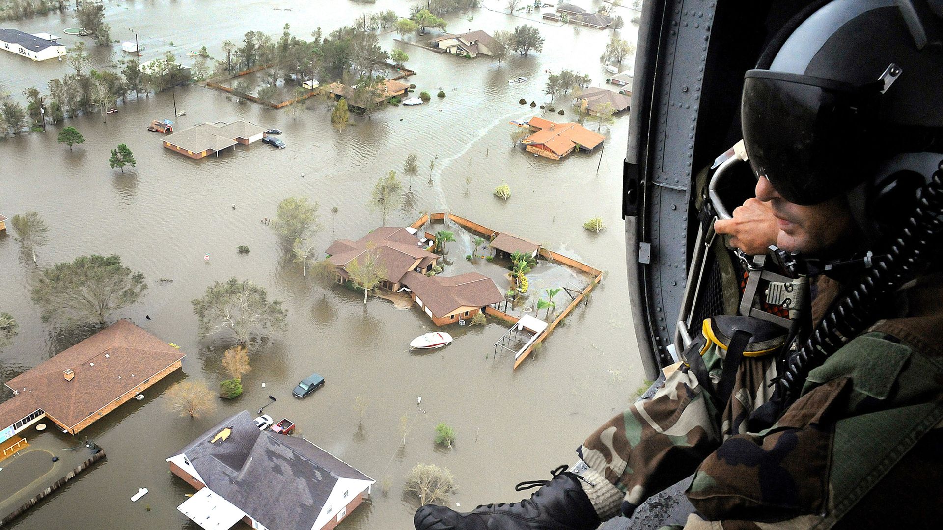 An Air Force Reserve pararescueman from the 920th Rescue Wing scans the landscape of Nederland, Texas in the aftermath of Hurricane Ike, 13 September 2008