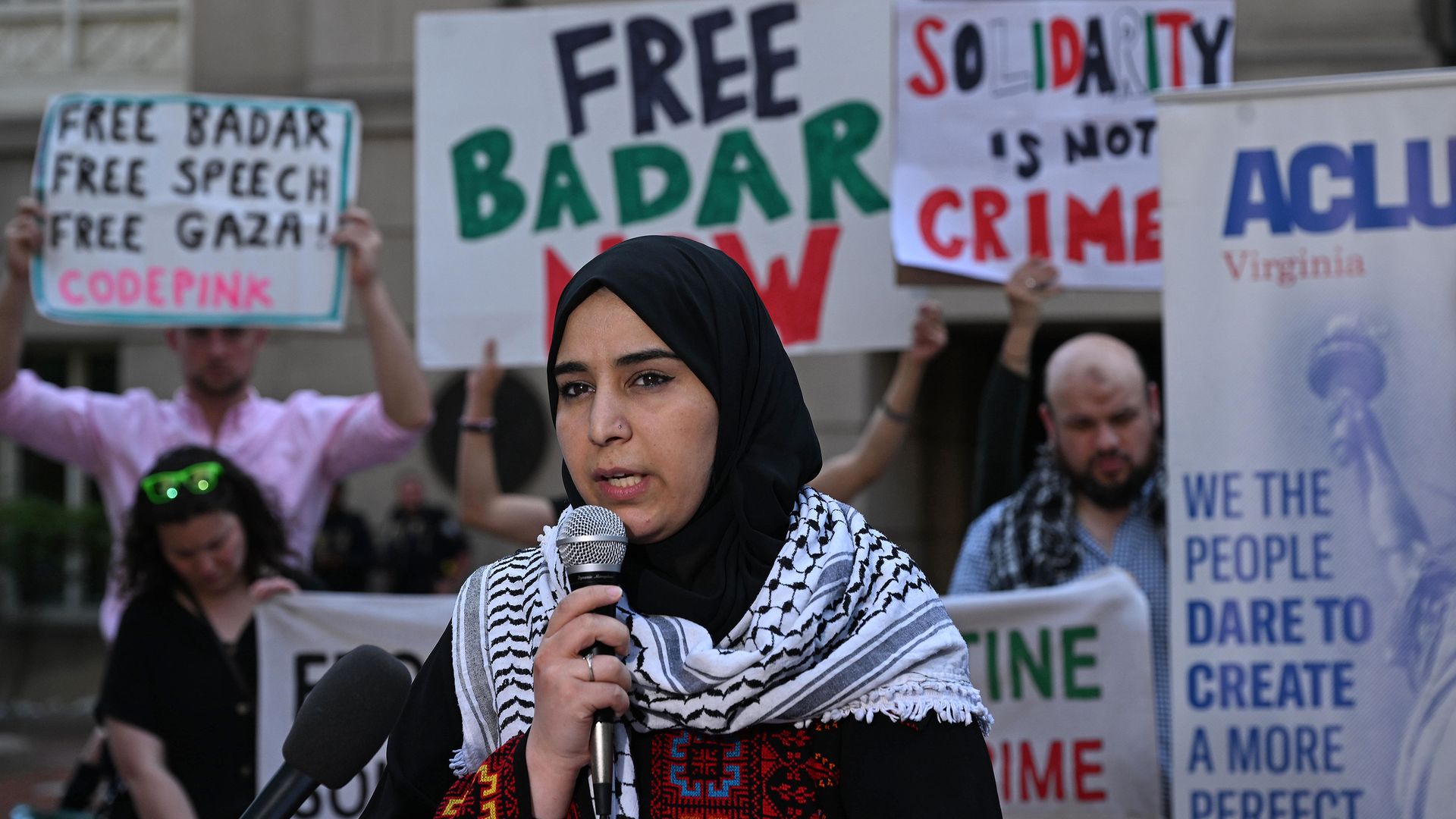 The wife Badar Khan Suri speaks to supporters seeking his release after a recent court hearing