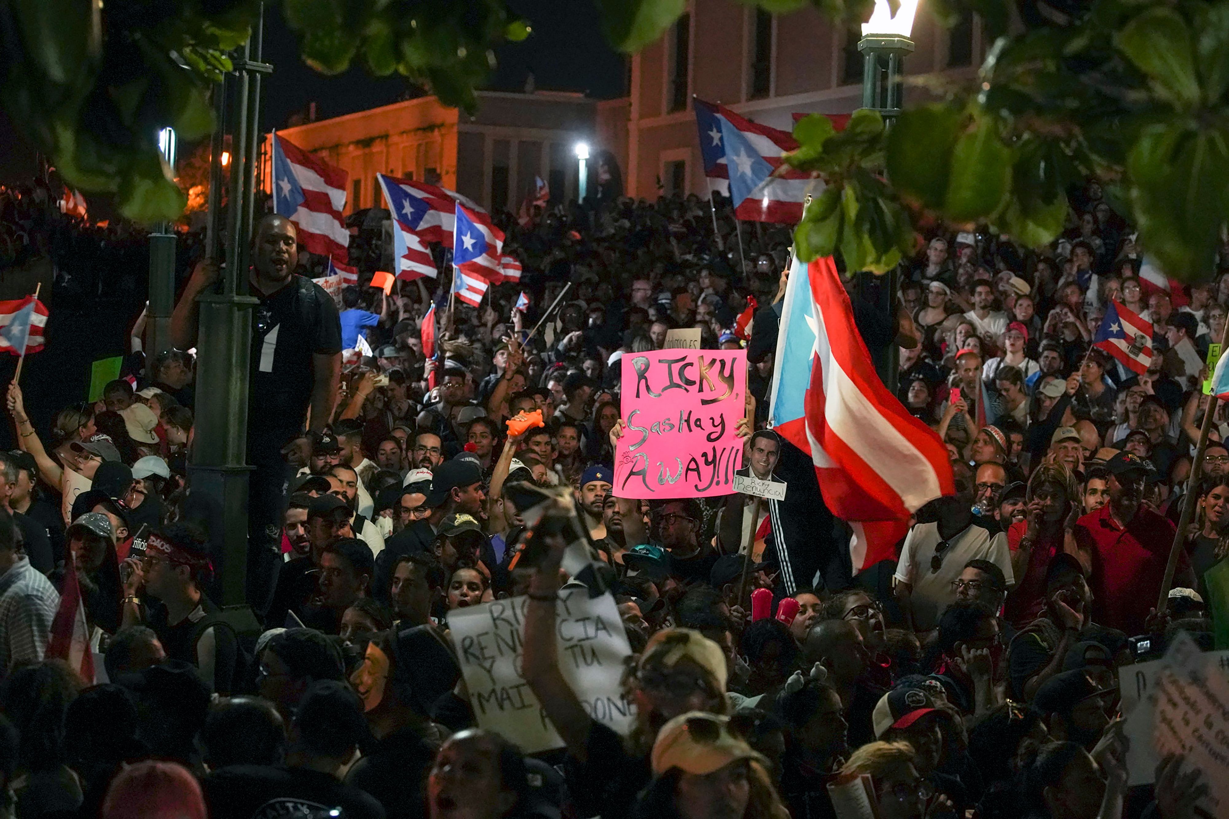 People take part of a demonstration demanding Governor Ricardo Rossello's resignation in San Juan.