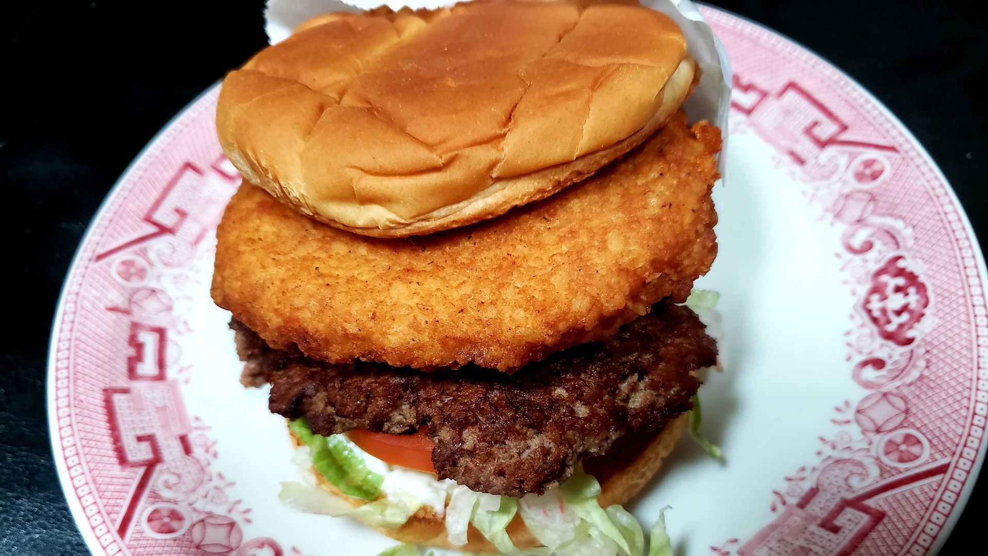 A burger with a cheese curd on top