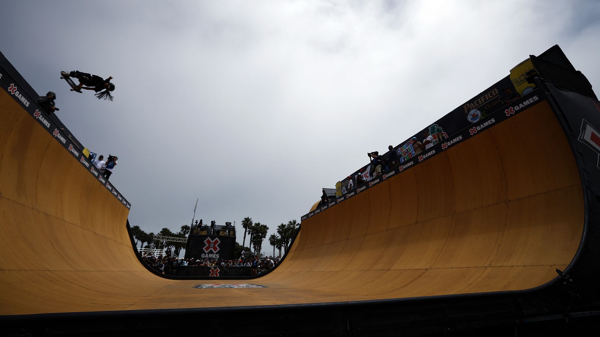 Woman skateboards on a ramp.