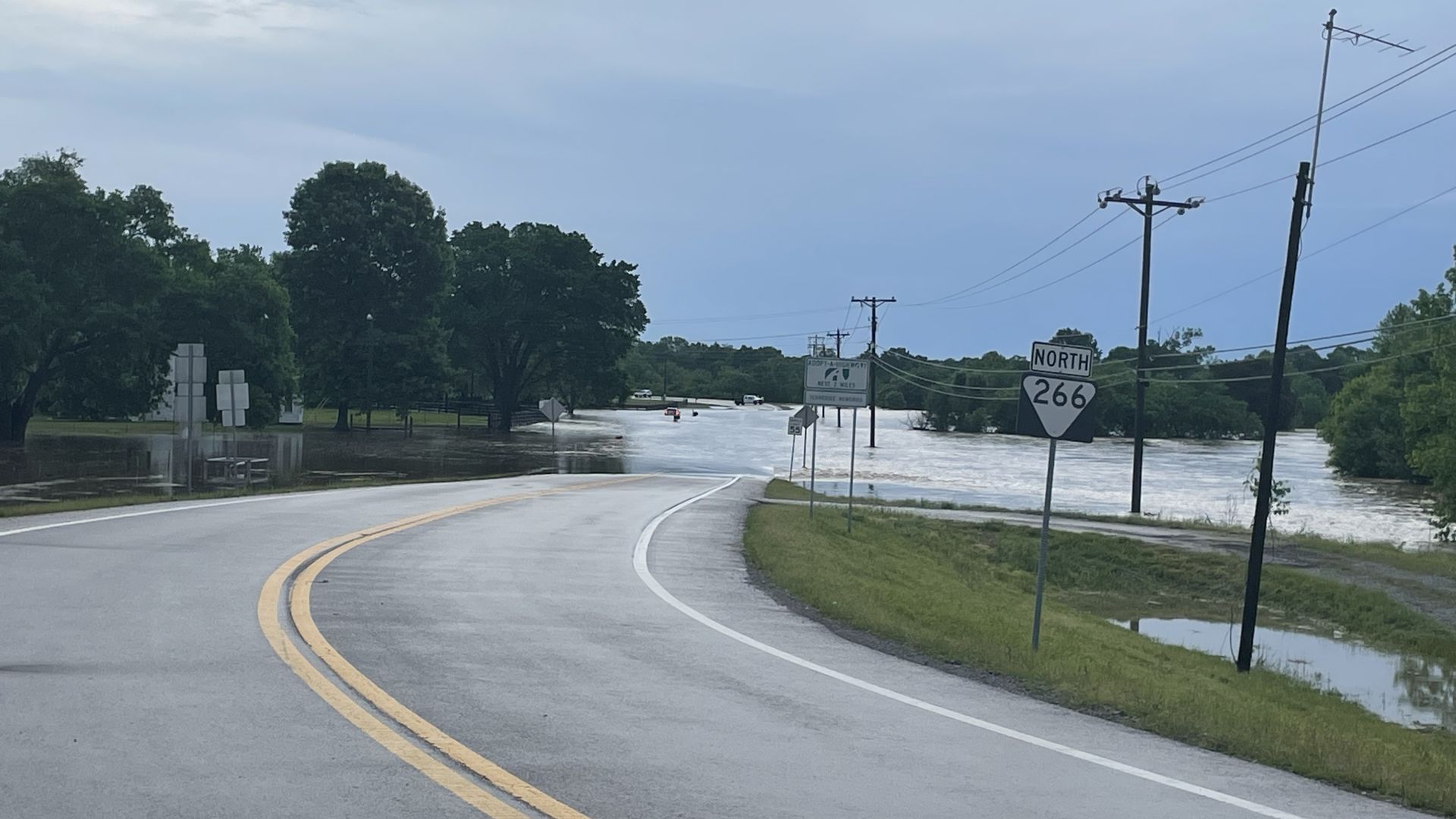Flood waters creep over a road.