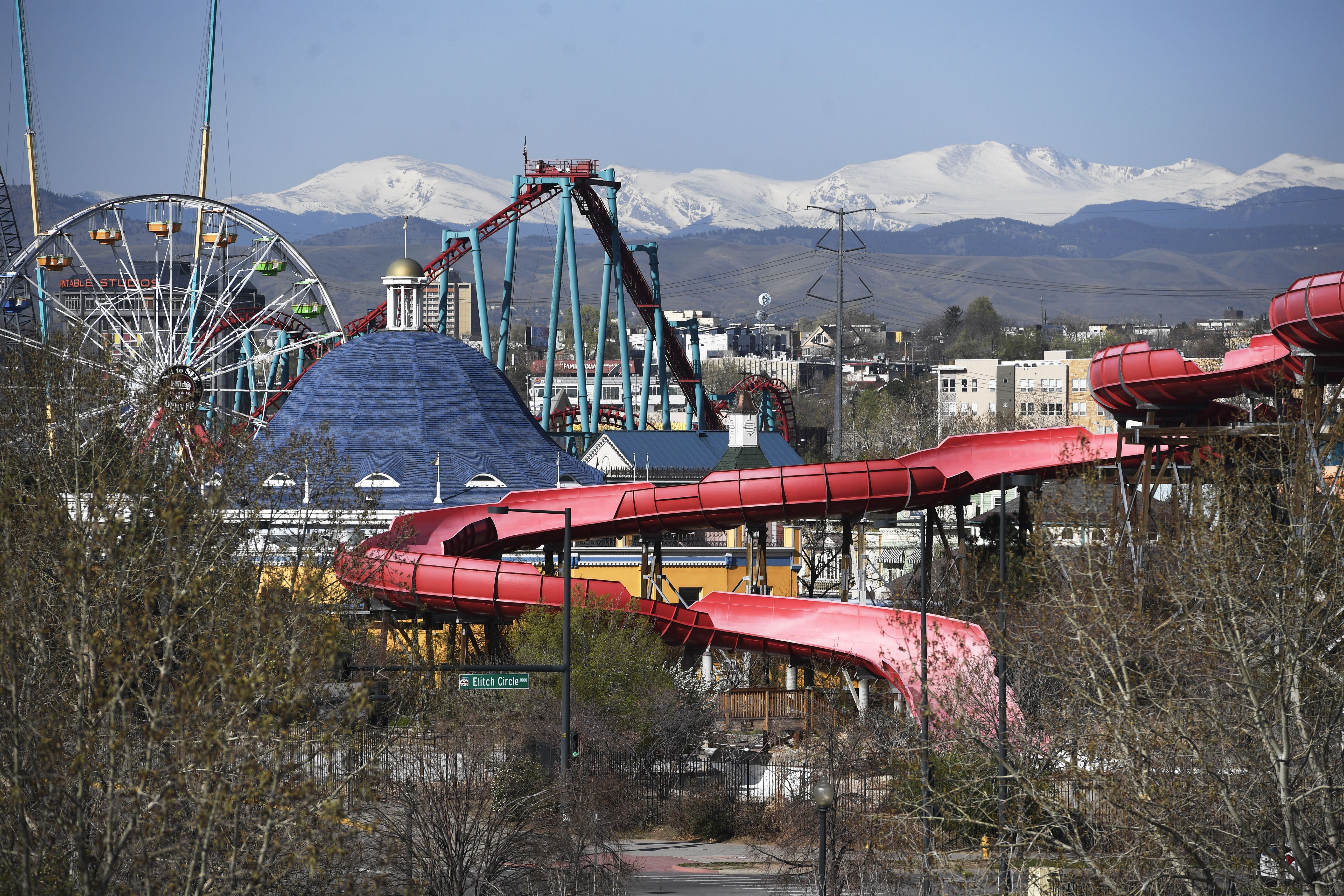 An amusement park in the distance, complete with a roller coaster. 