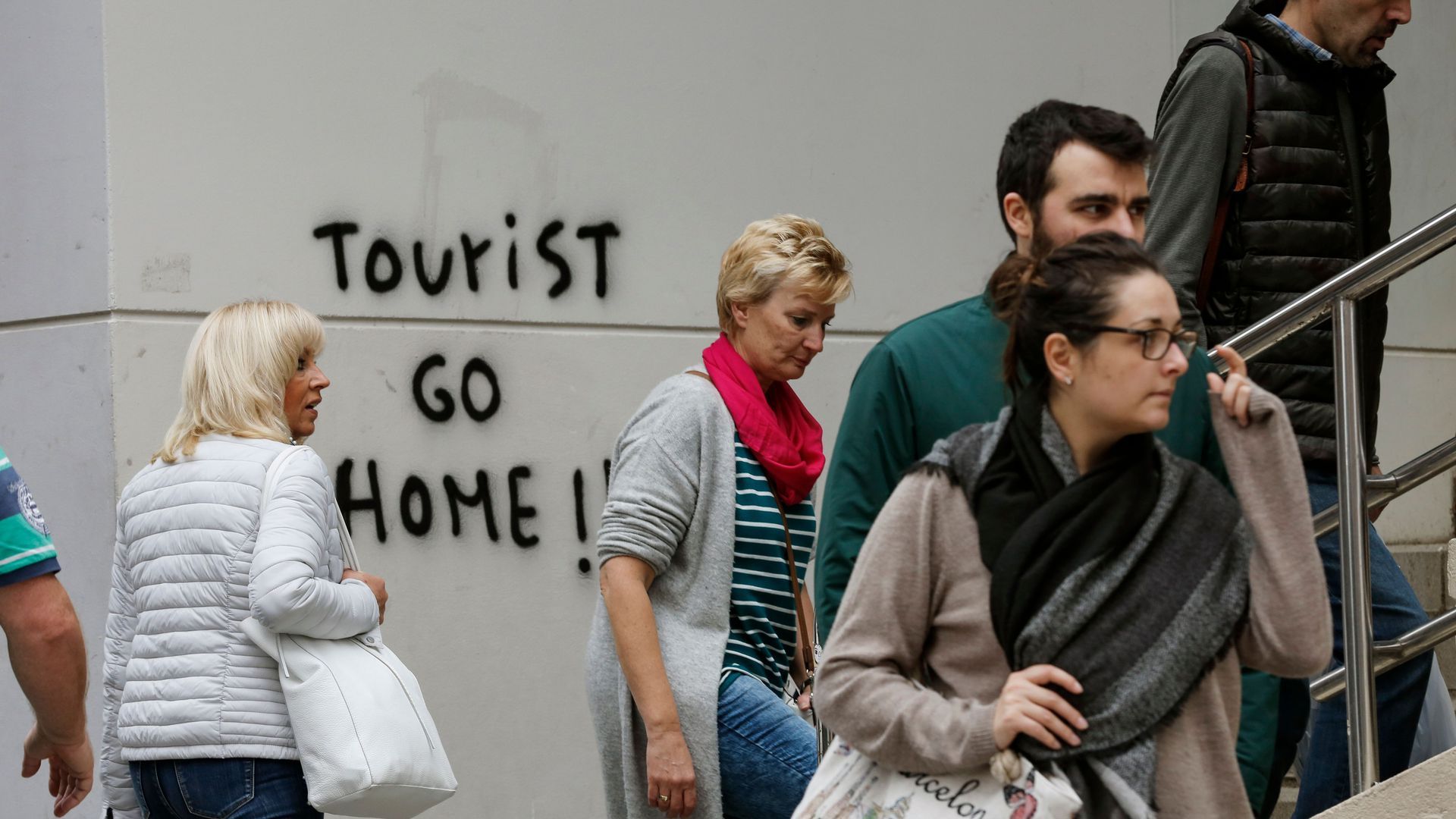 Graffiti that says "Tourist go home"
