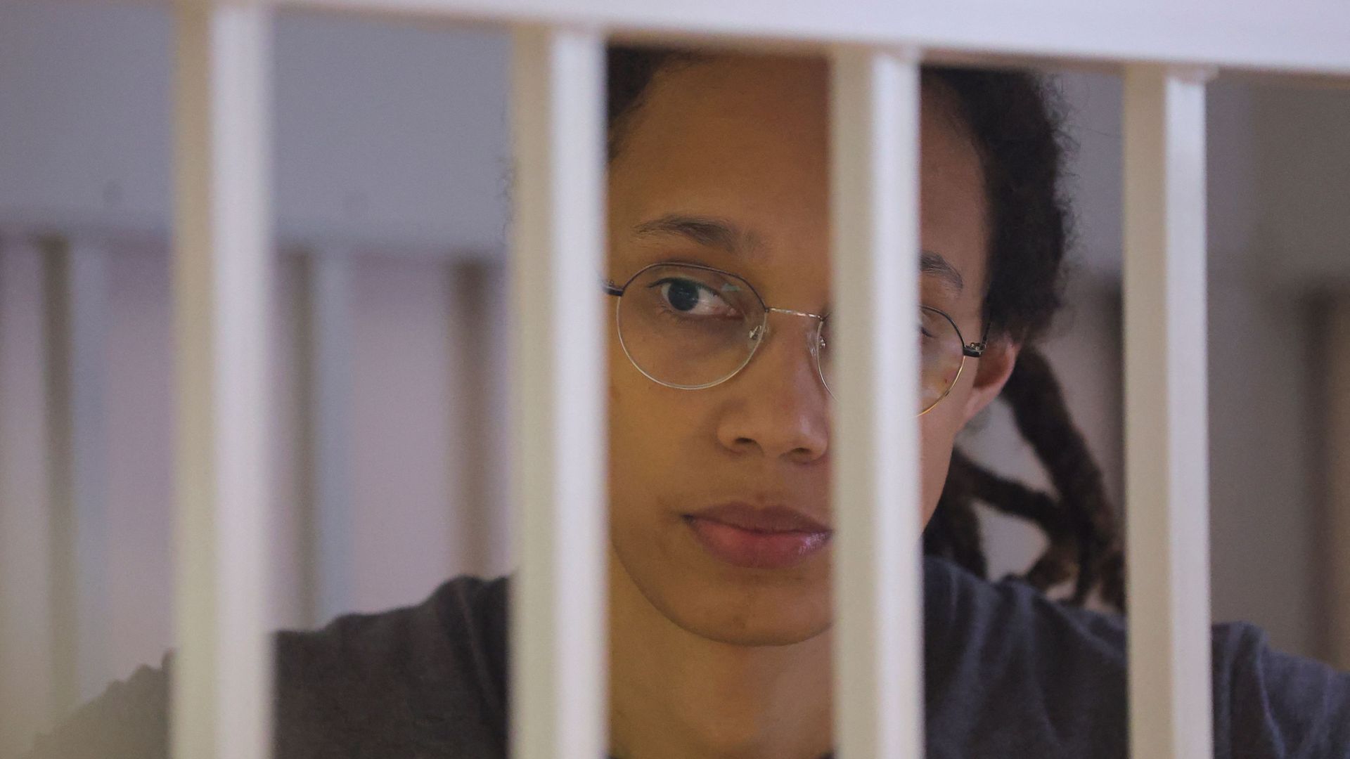 Brittney Griner waits for the verdict inside a defendants' cage during a hearing in Khimki outside Moscow, on August 4, 2022