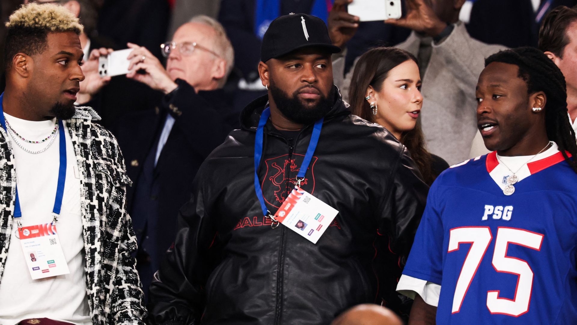 Saints players Cam Jordan, Davon Godchaux and Alvin Kamara at a soccer match.