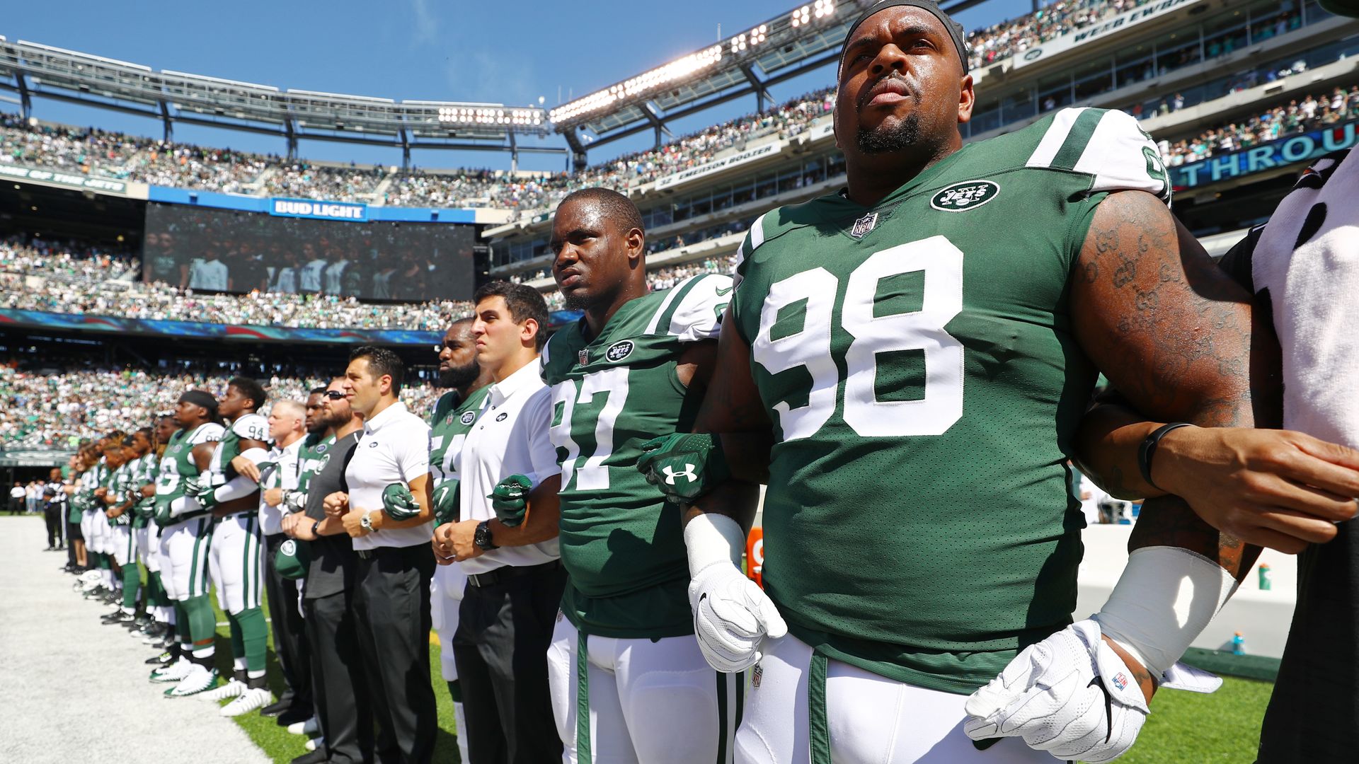 New York Jets players and coaches during the national anthem