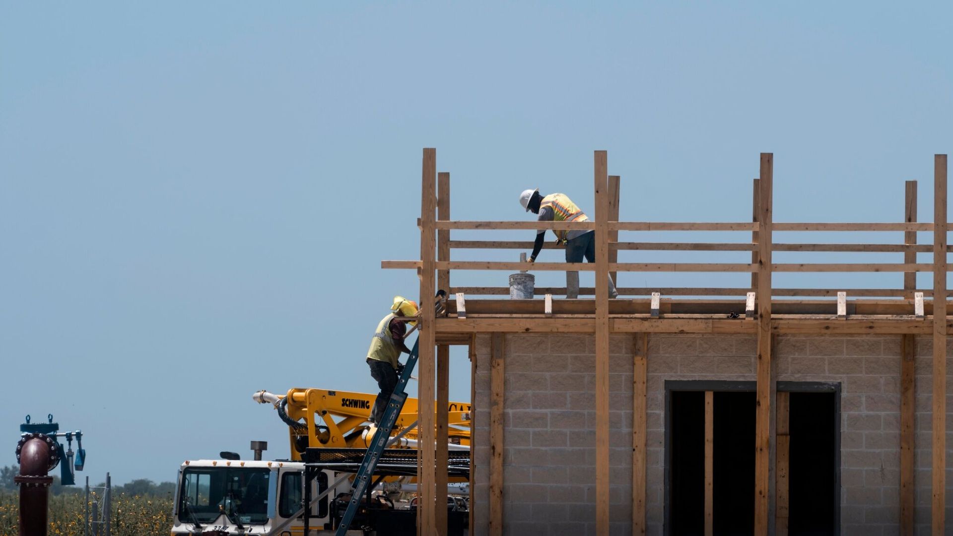 Construction workers in Kyle, Texas atop of a half-constructed structure