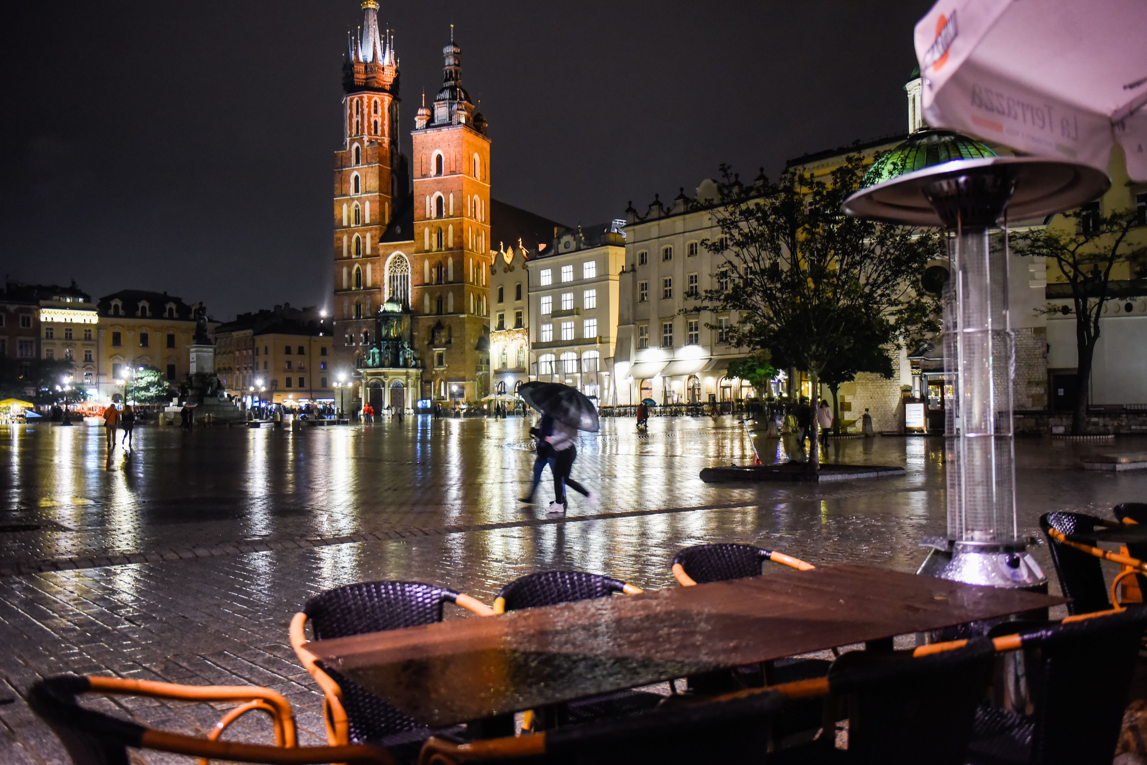 Empty tables from an outdoor garden of a closed restaurant at Krakow's UNESCO listed Main Square in Poland