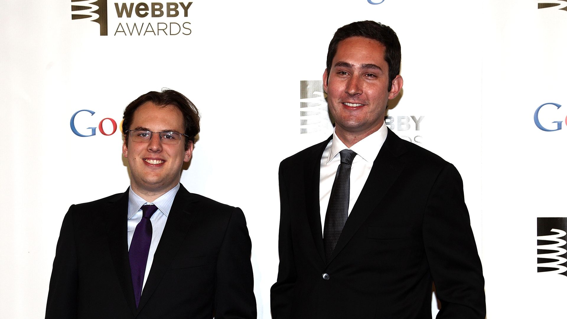 Instagram co-founders Kevin Systrom and Mike Krieger pose at for a photo at an event