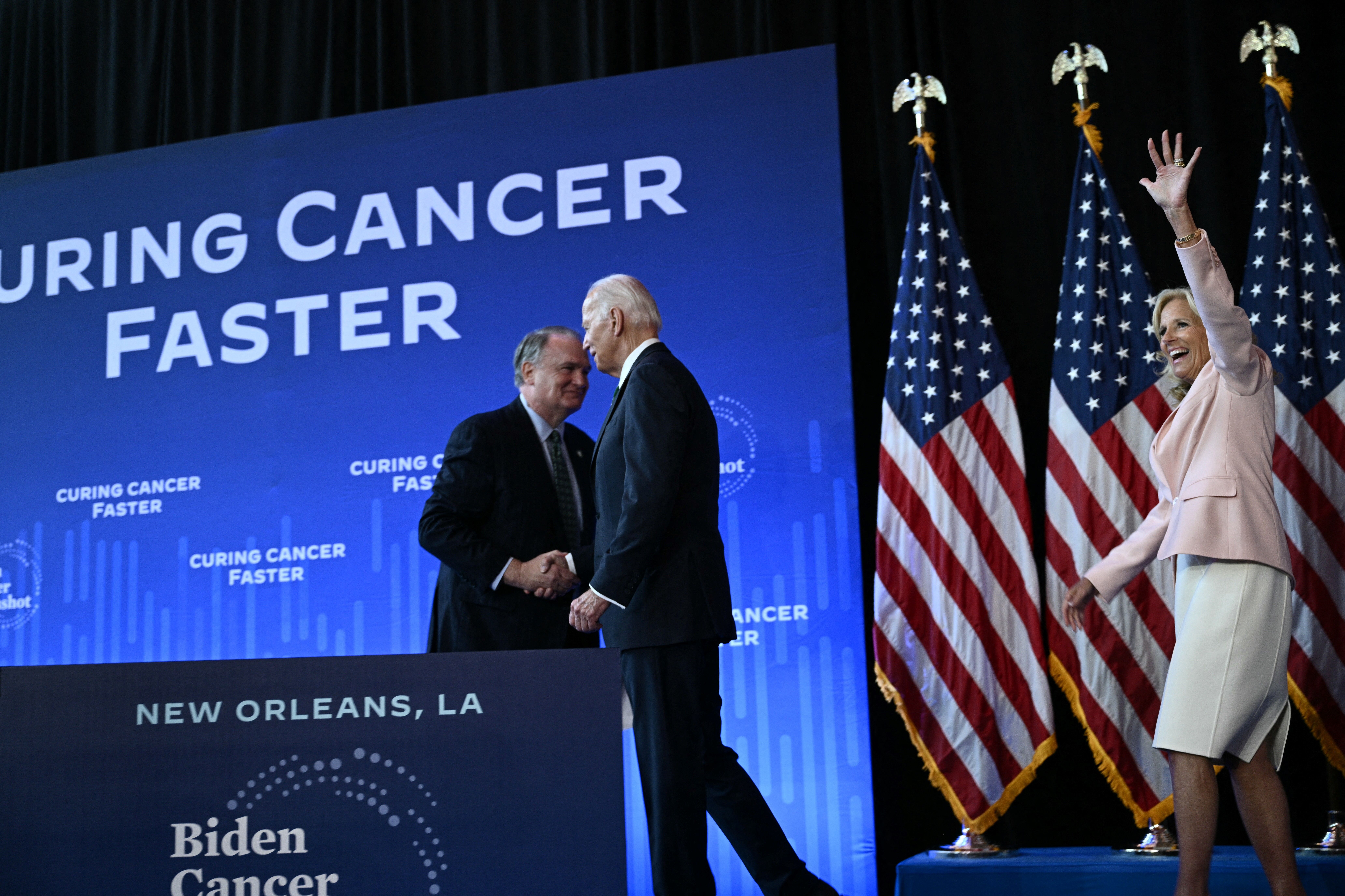 Photo shows President Biden and Jill Biden on stage.
